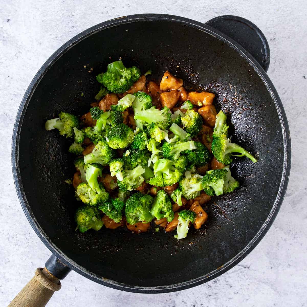 Broccoli added to the pan/wok.