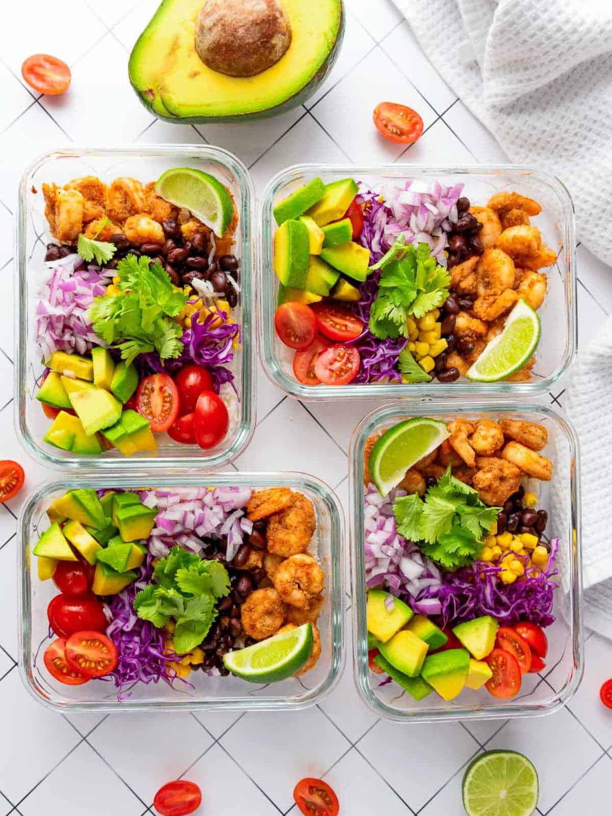 Shrimp taco rice bowls in meal prep containers.