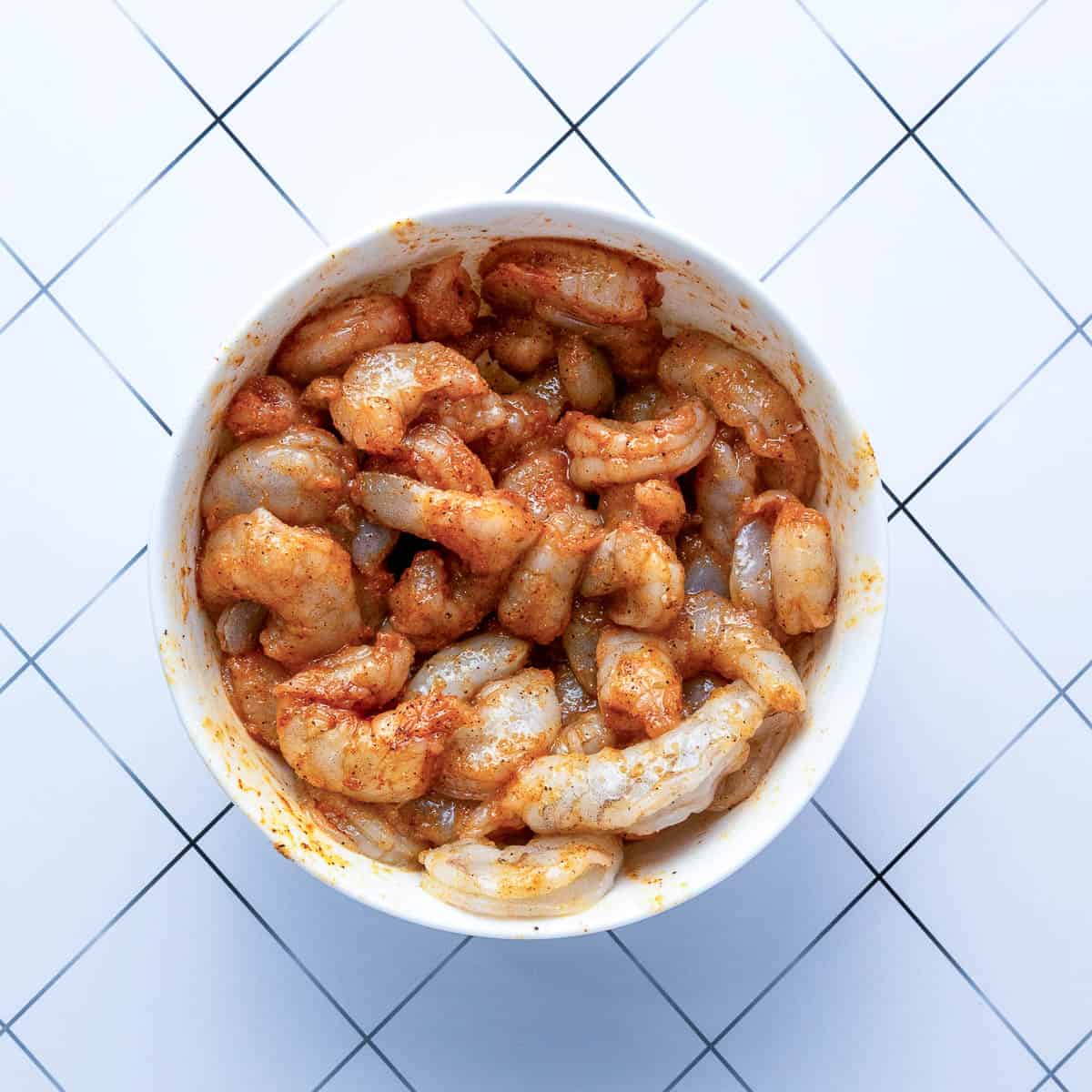 Marinated shrimp in a mixing bowl.