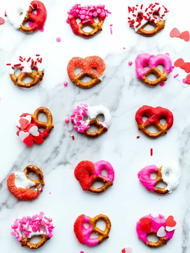 Decorated pretzels placed on a marble surface.