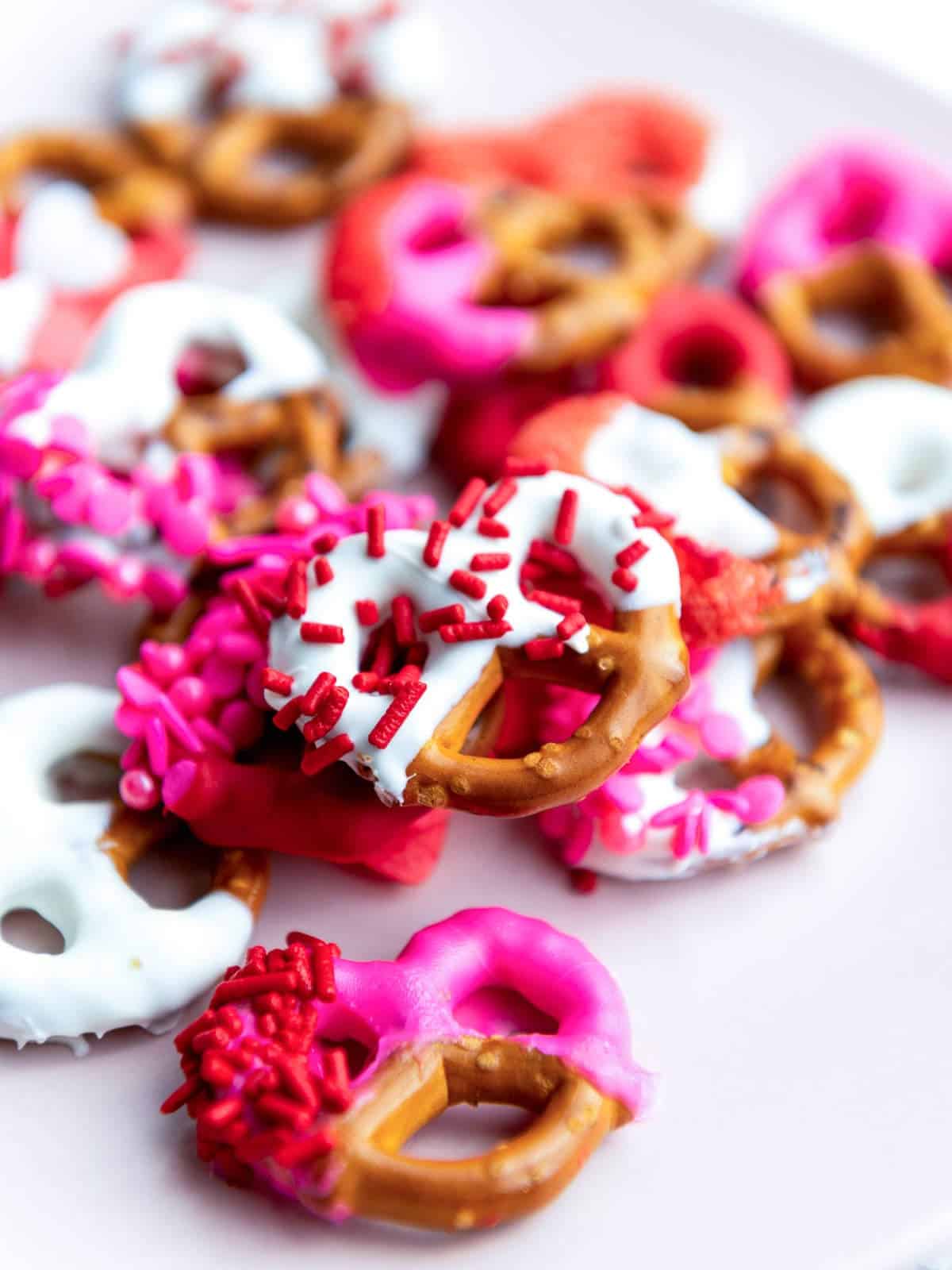 Close up of decorated pretzels placed on a white plate.