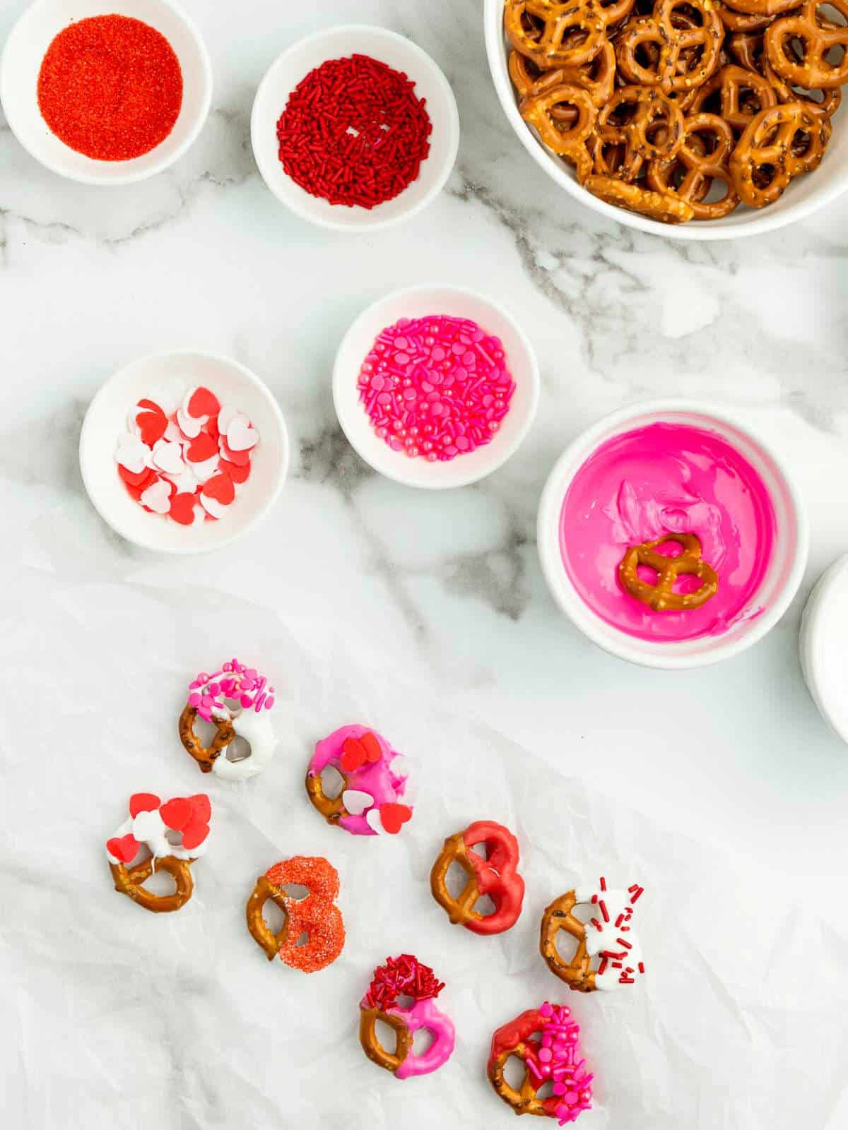 Candy-dipped pretzels decorated with sprinkles.