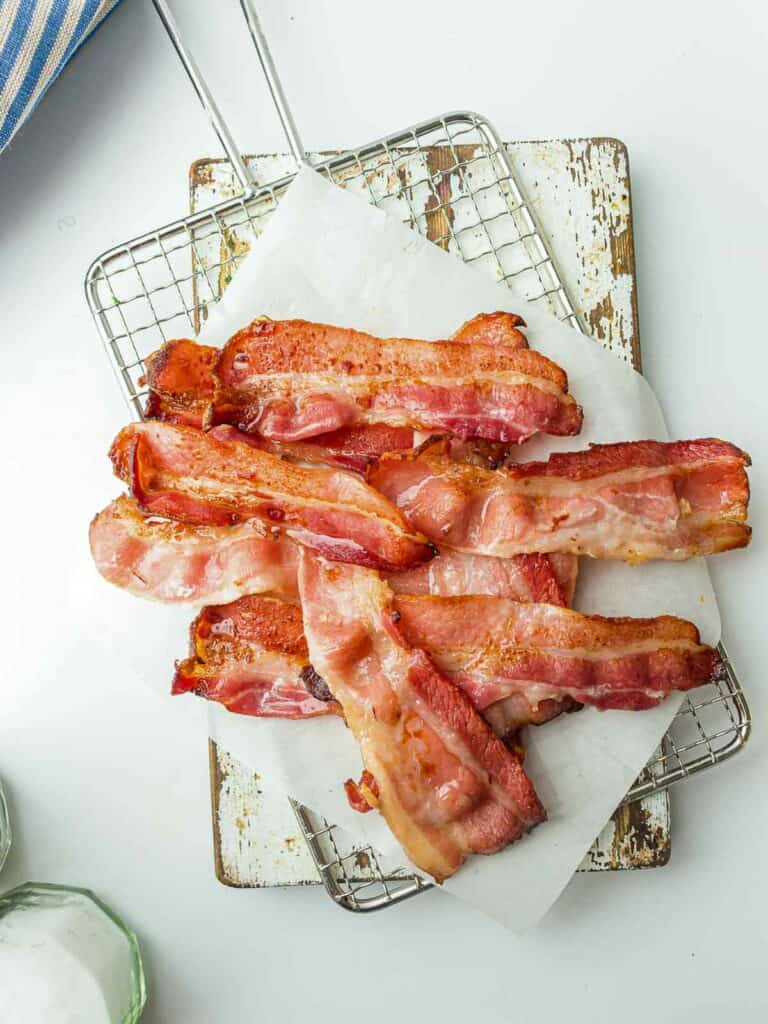 Cooked bacon on a parchment paper.