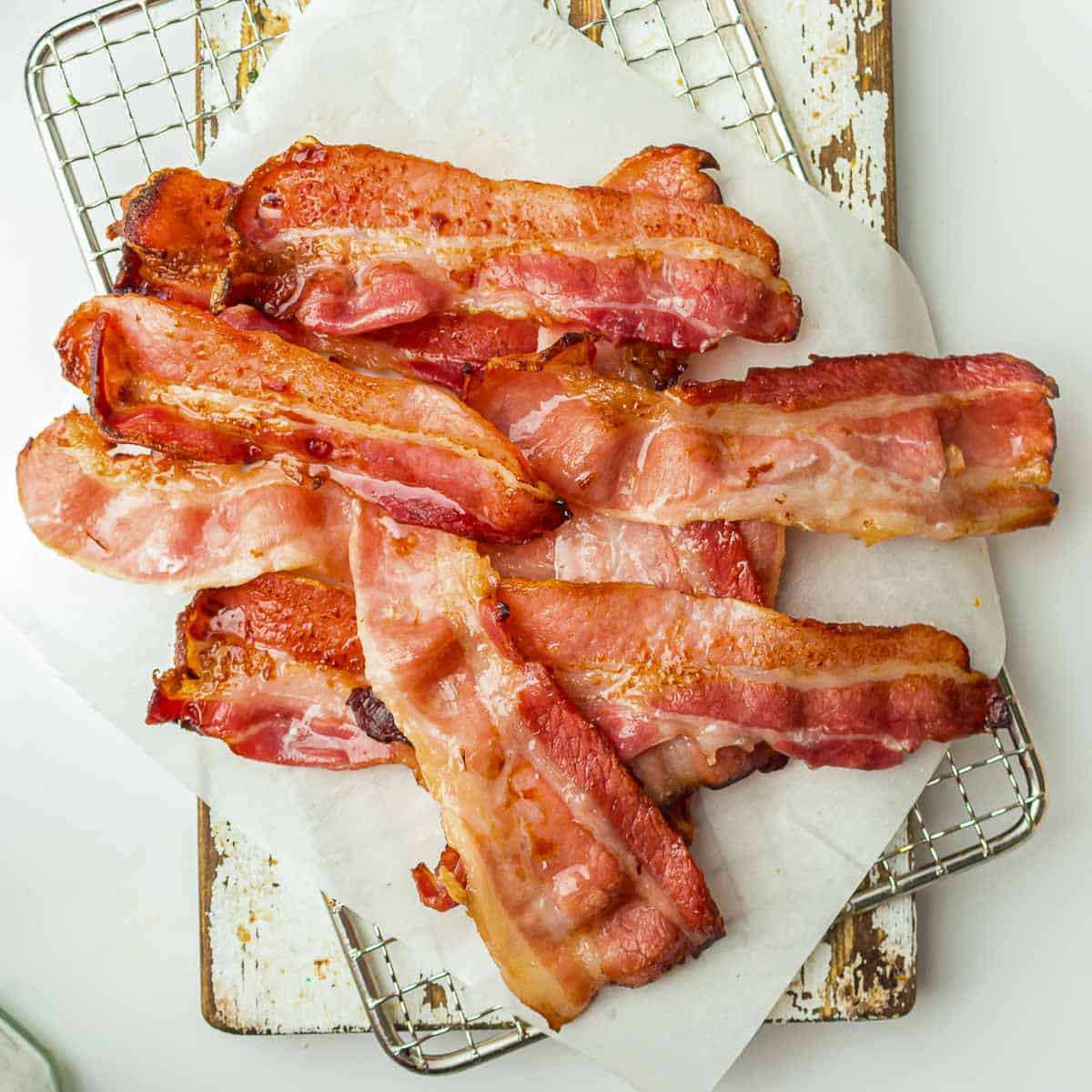 Close up of cooked bacon on a wire rack.