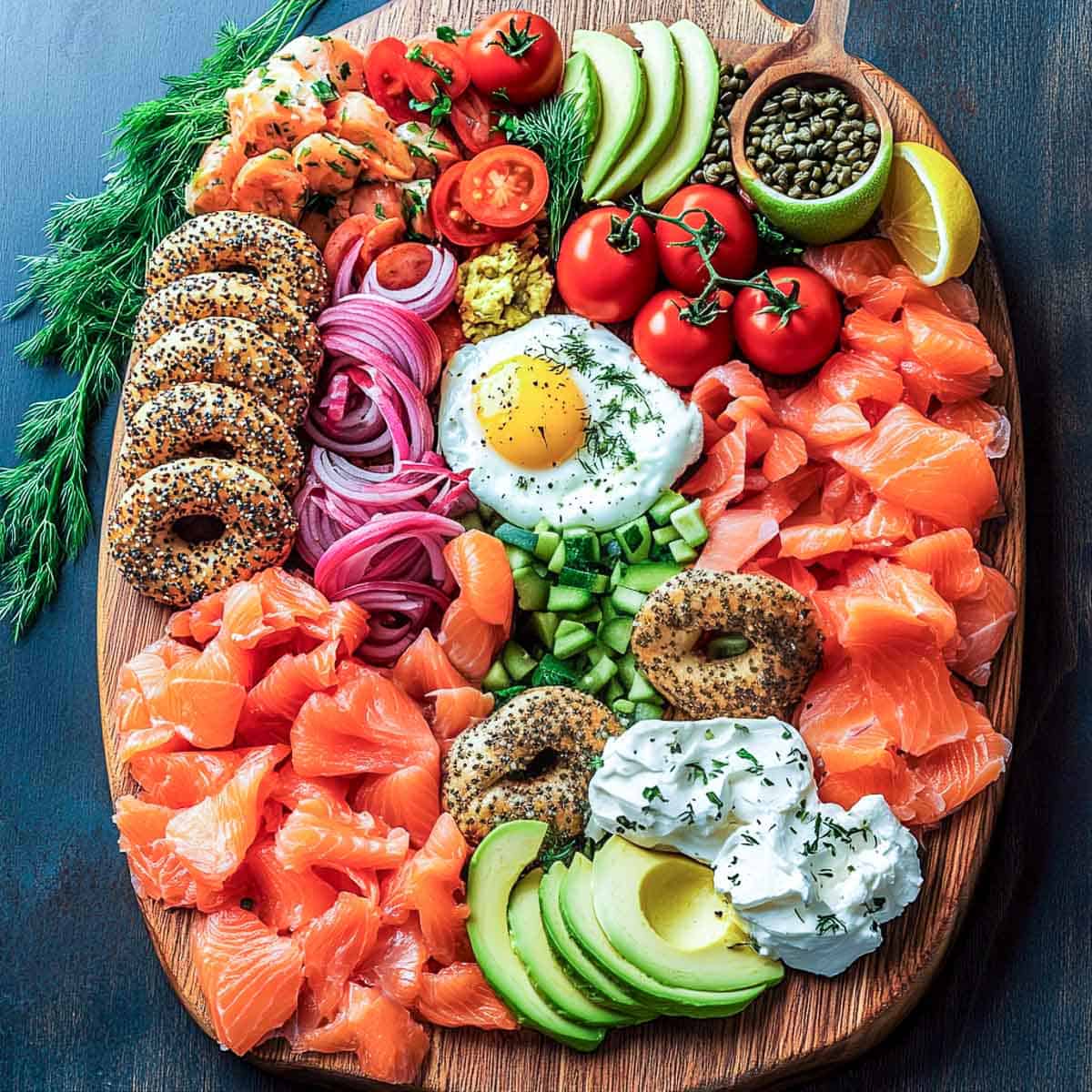 Bagel breakfast board with bagels, salmon, cream cheese, and eggs.