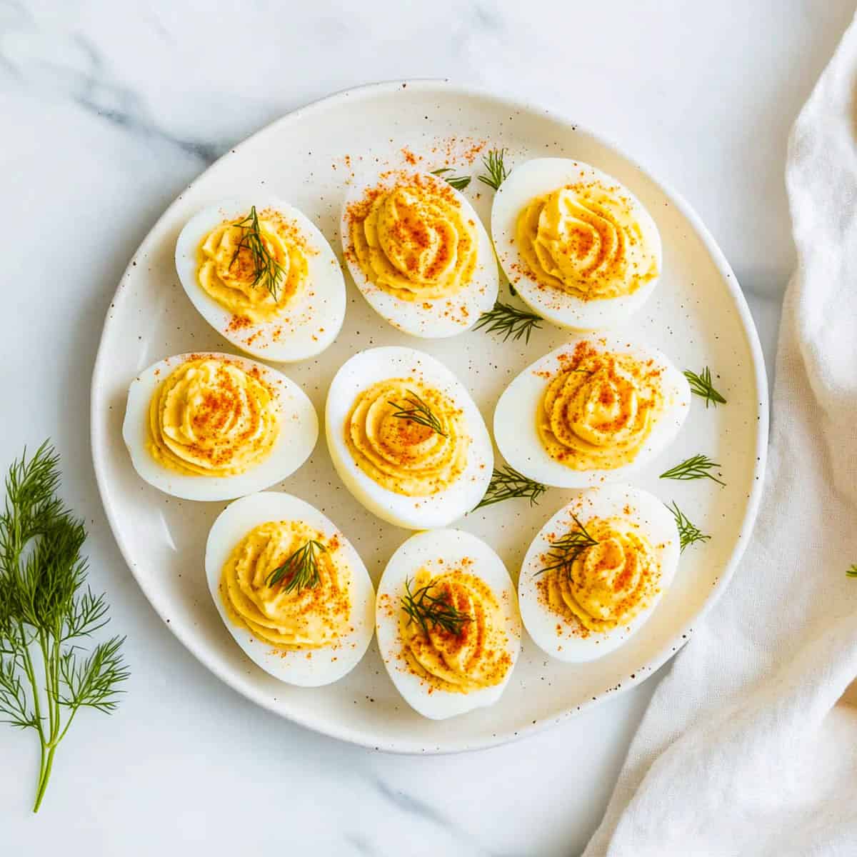 Classic deviled eggs on a white plate.