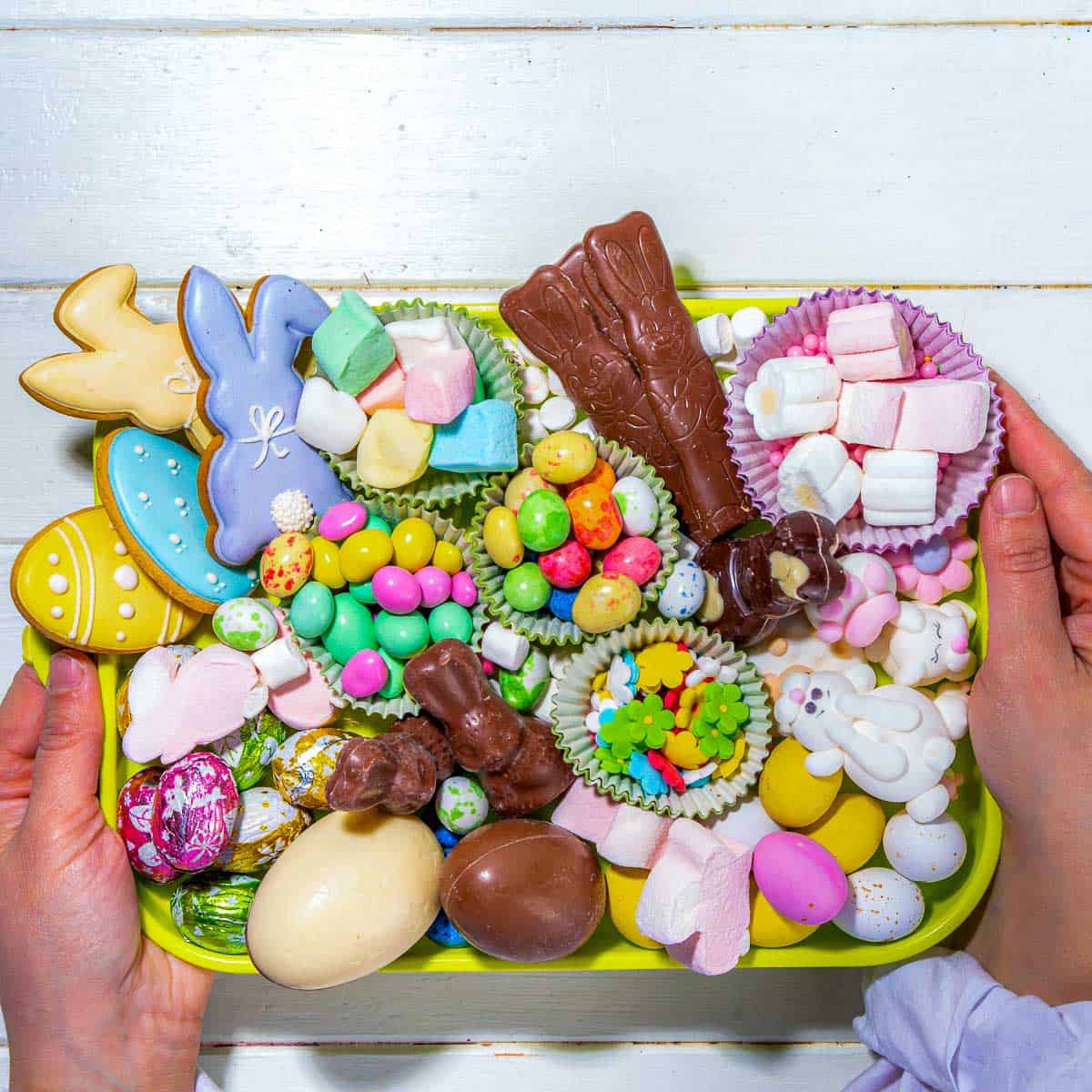 Woman holding a small Easter candy tray.