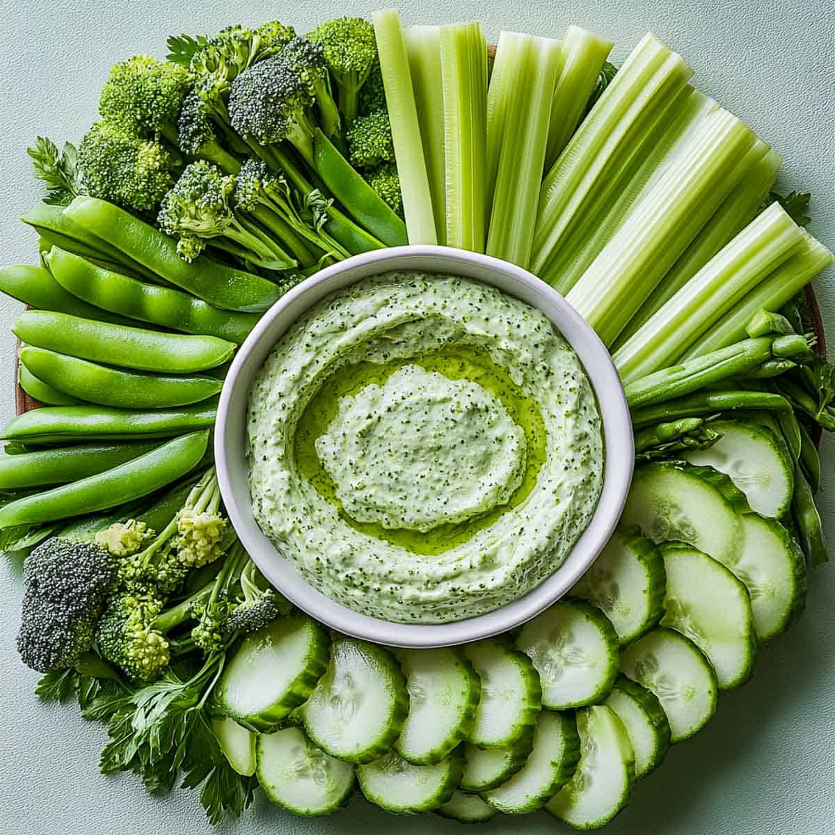 Crisp veggie platter placed on a light green surface.