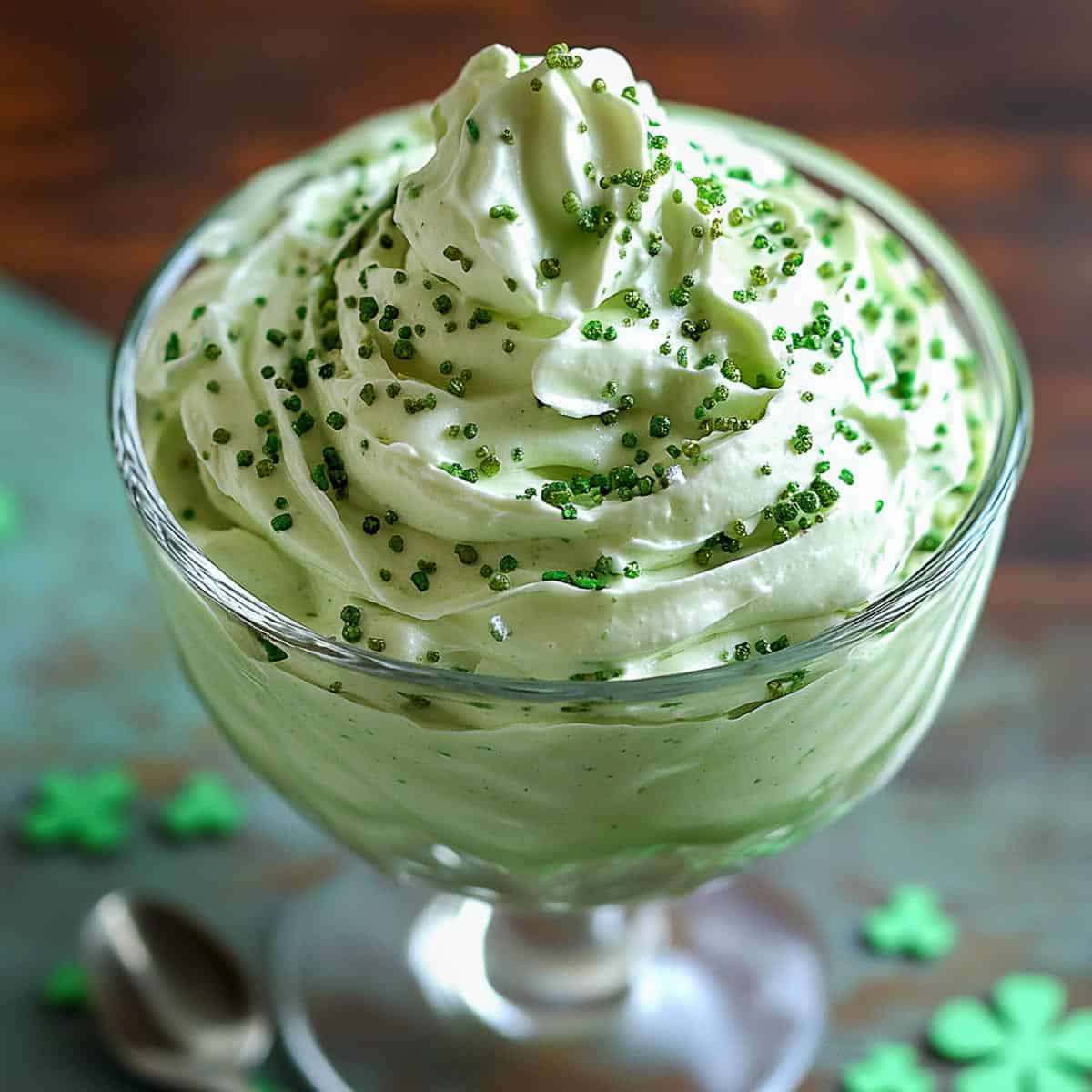 Shamrock cheesecake fluff in a glass serving bowl.