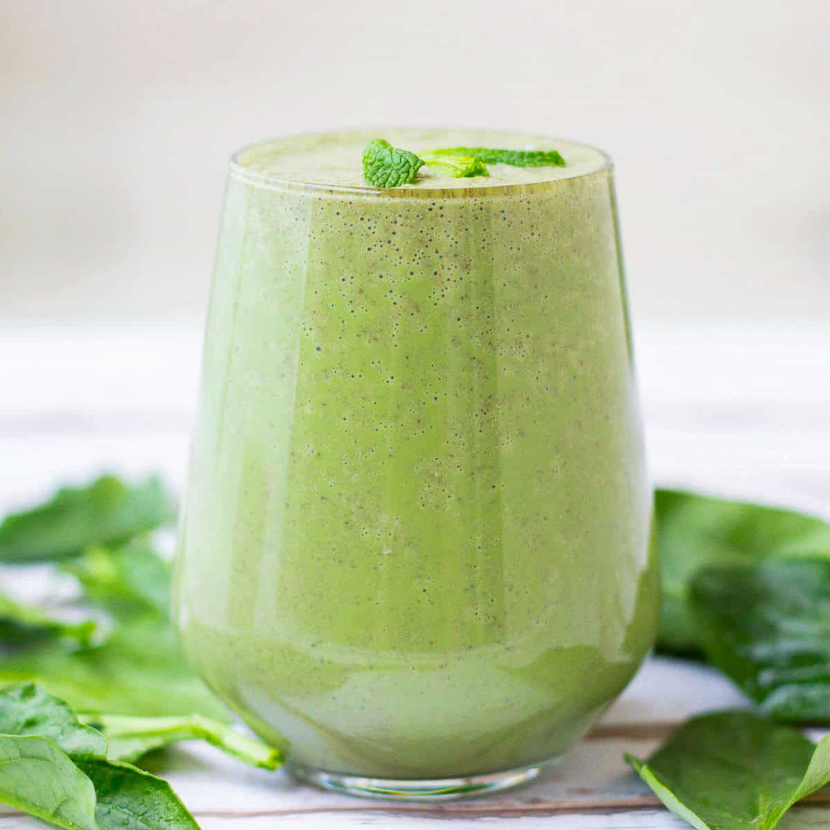 Side view of a glass of shamrock smoothie.