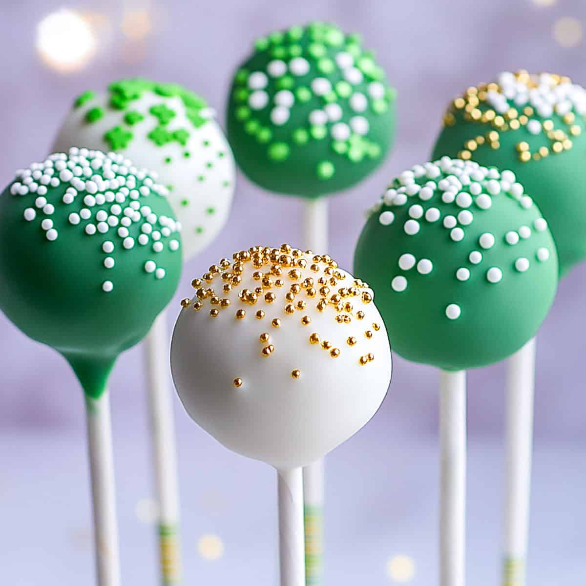 Side view of white and green St. Patrick's Day cake pops.