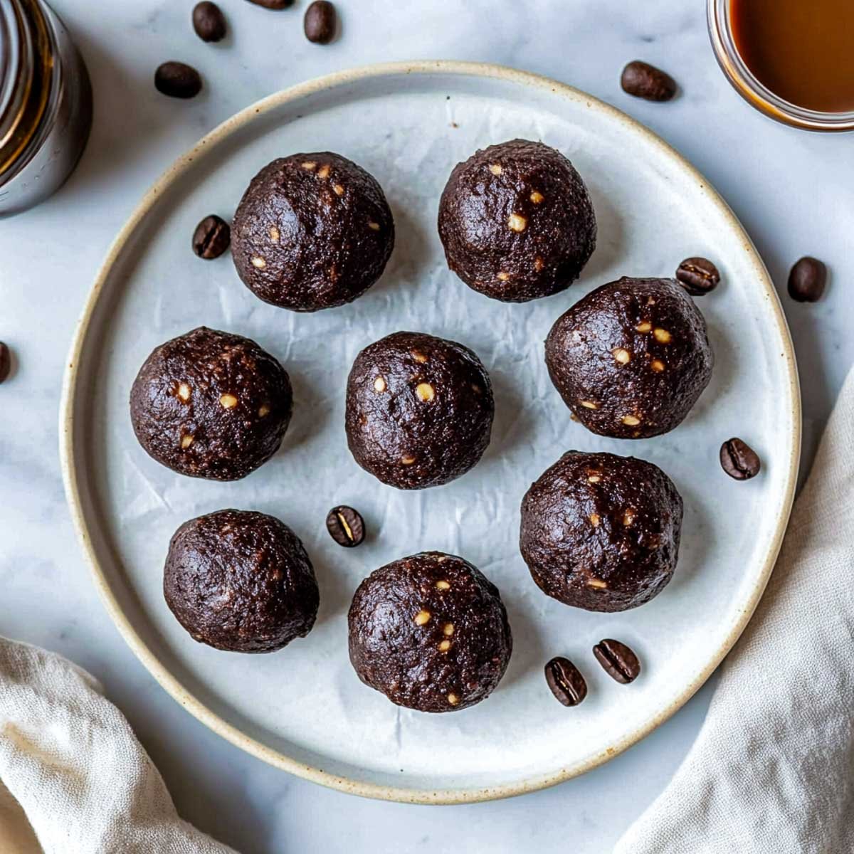 Espresso bronie protein bites on a white serving plate.