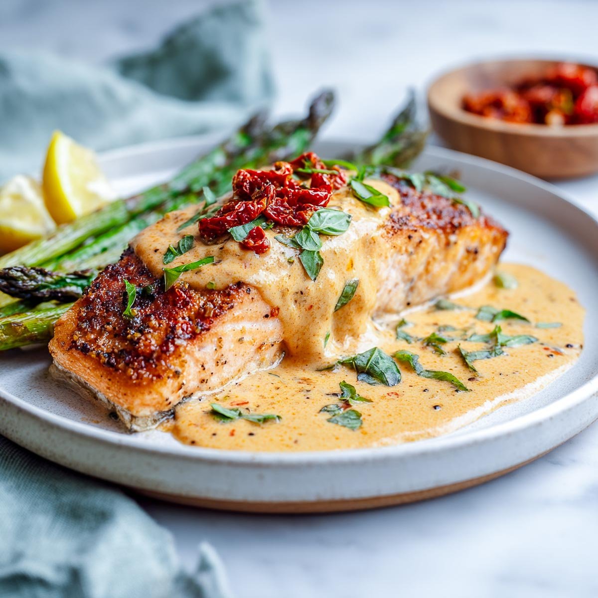 Seared salmon with creamy sun-dried tomato sauce and roasted asparagus.