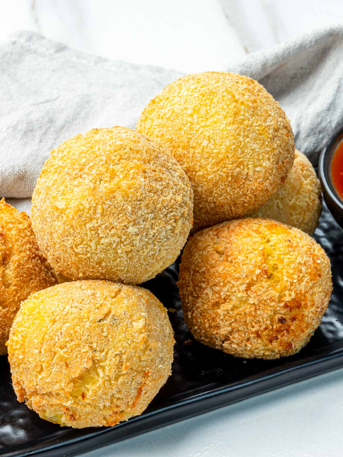 Close-up of crunchy potato cheese croquettes showing their crisp panko coating.