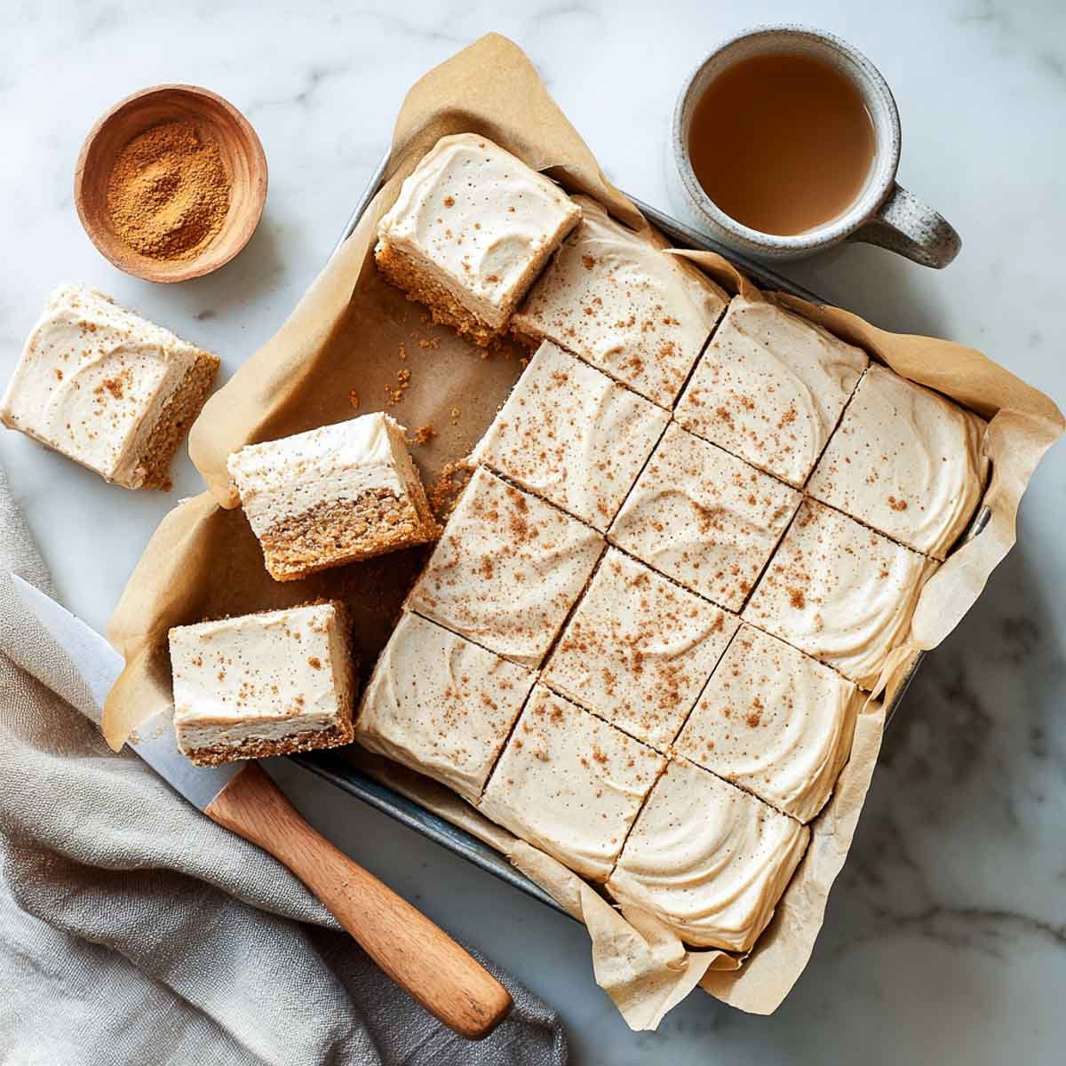 Top-down view of frosted chai cookie bars cut into squares.
