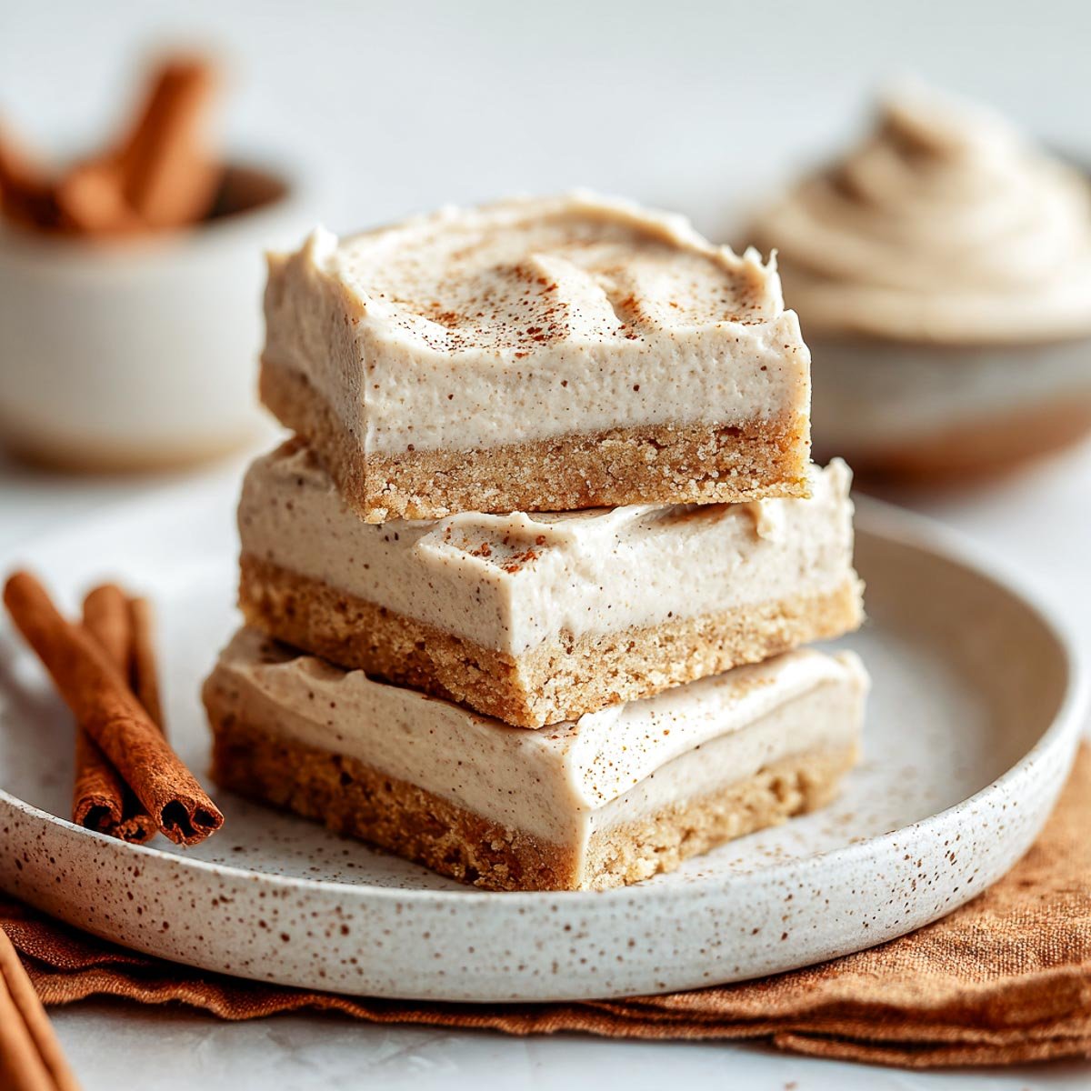Soft cookie bars with chai frosting and cinnamon sprinkled on top.