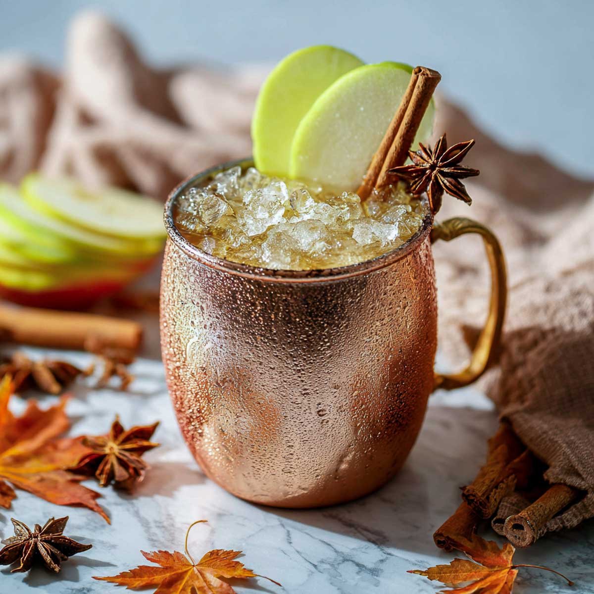 Cinnamon apple Moscow mule in copper mug.