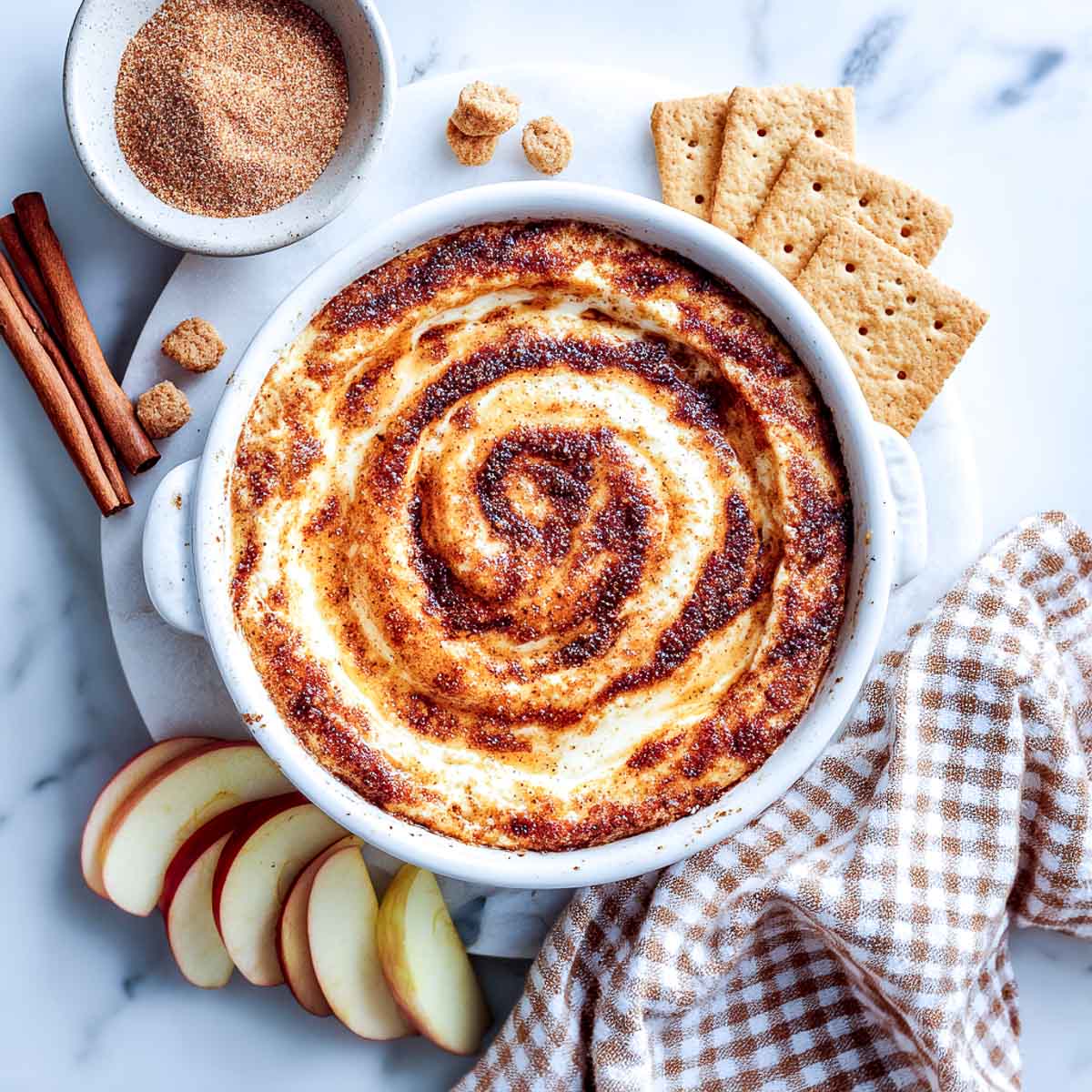Creamy cinnamon roll cottage cheese dip served warm with apples and crackers.