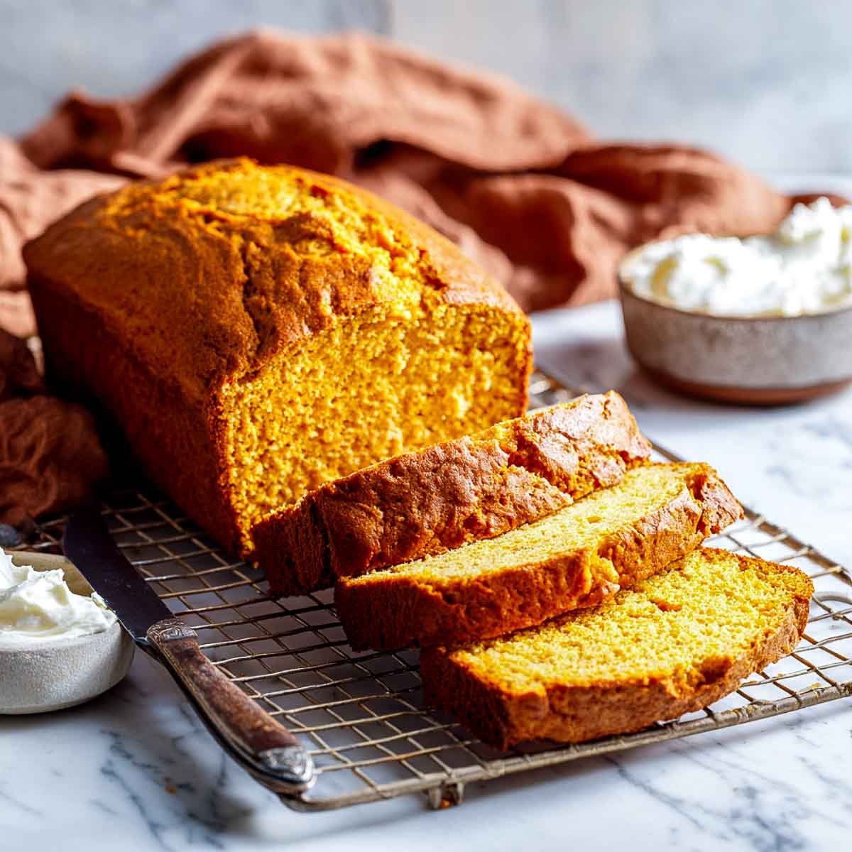 Freshly baked pumpkin bread on cooling rack.