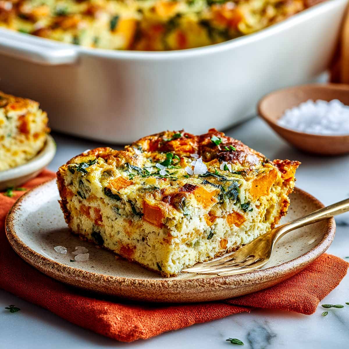 Golden cottage cheese breakfast casserole with sweet potato, spinach, and herbs.