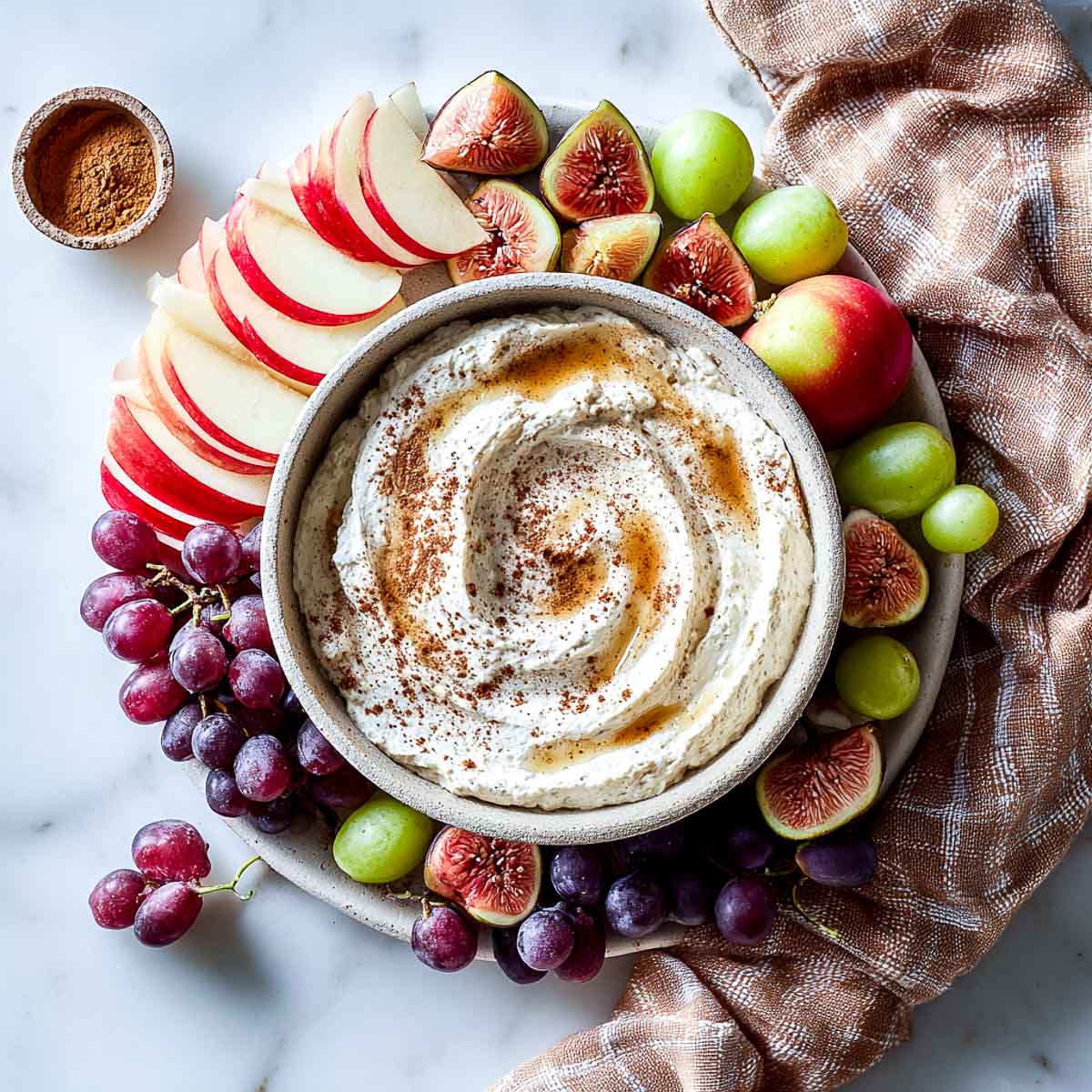 Creamy fall spiced cottage cheese dip with apples, figs, and grapes.