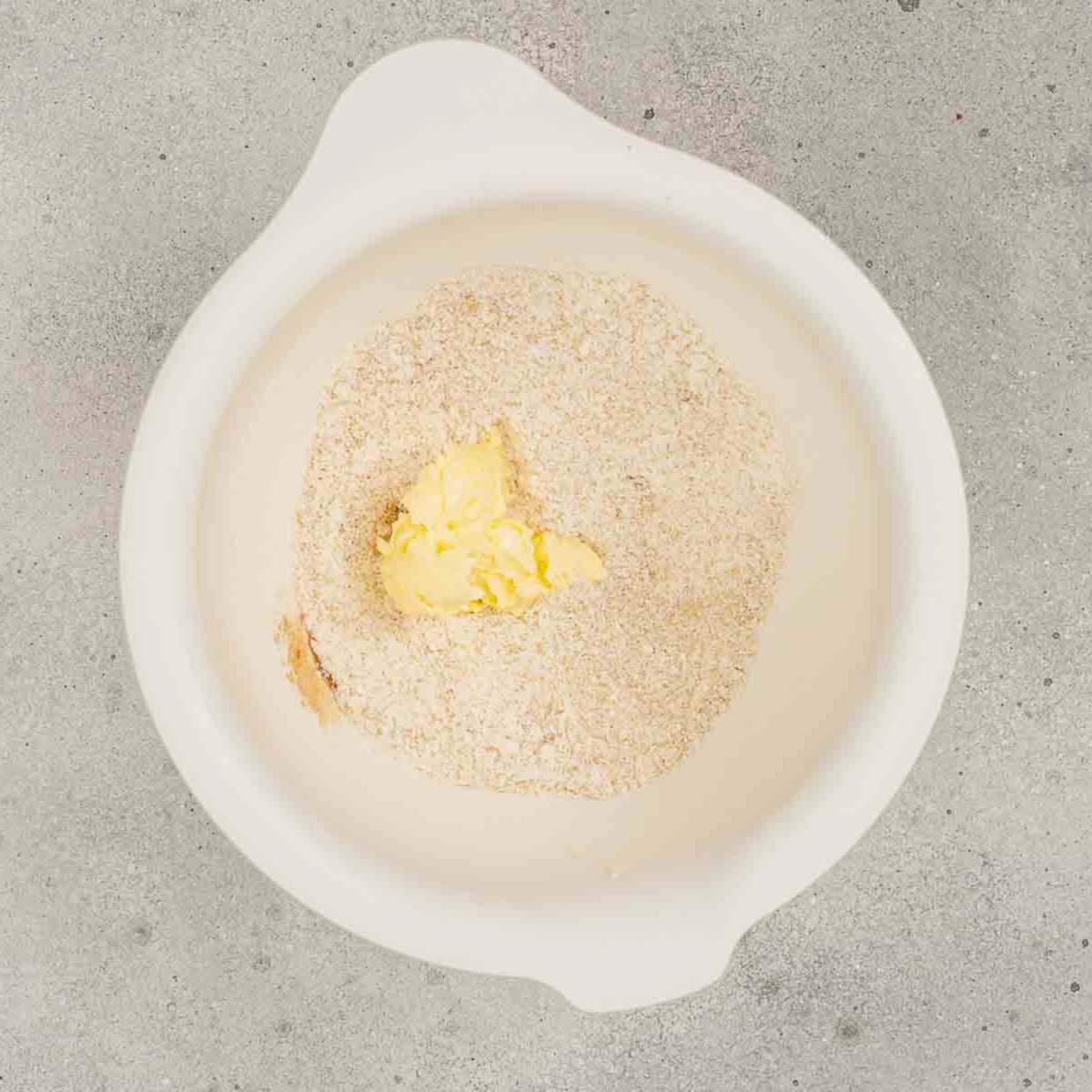 Crumb topping mixture of flour, brown sugar, cinnamon, and butter in a bowl.