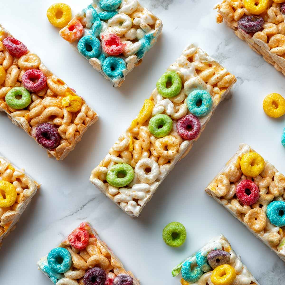 Cereal bars made with peanut butter, puffed rice, and rainbow cereal.