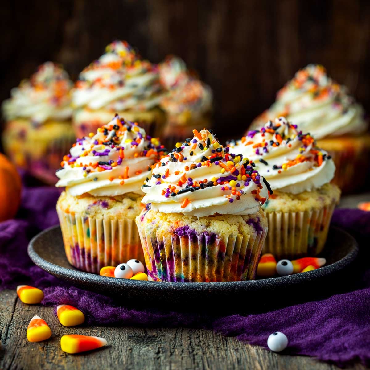 Halloween funfetti cupcakes with sprinkles baked inside and frosting swirls on top.
