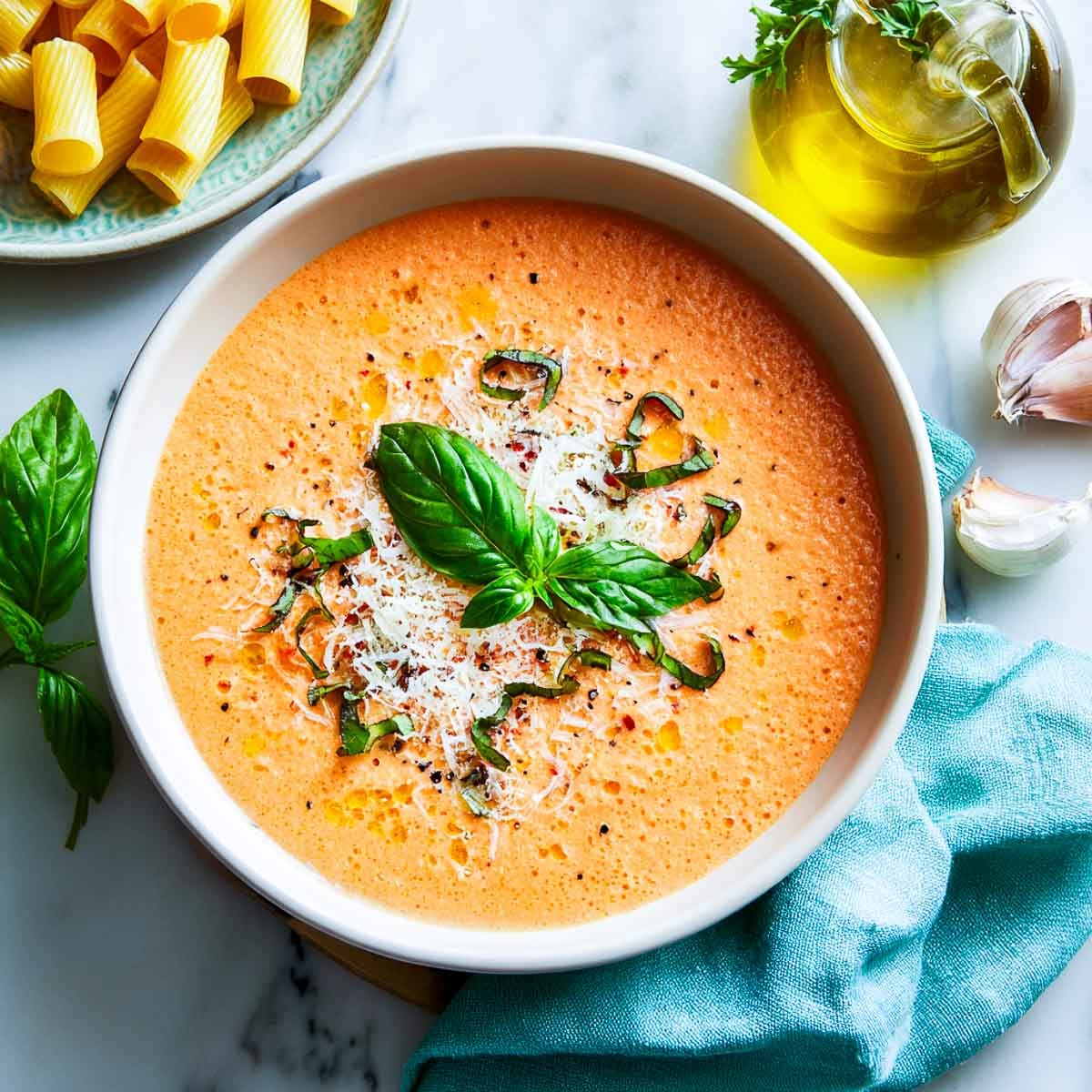 Top-down view of creamy tomato cottage cheese sauce with basil and cheese on top.