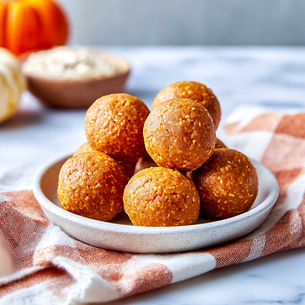 Cottage cheese pumpkin protein bites on a small plate.