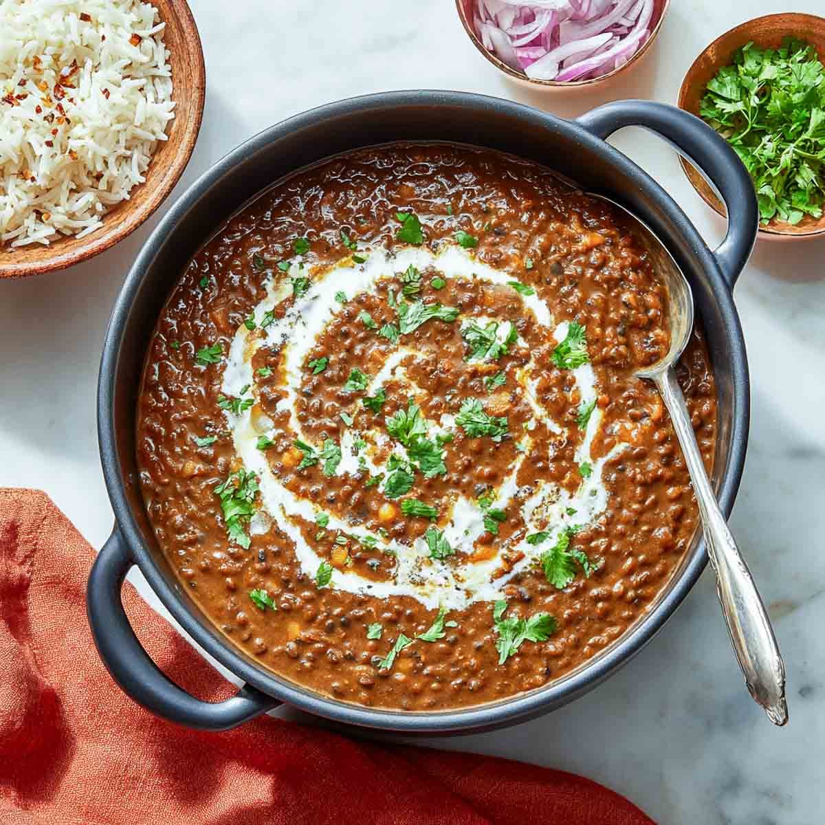 Dal makhani cooked in a heavy bottom pan.