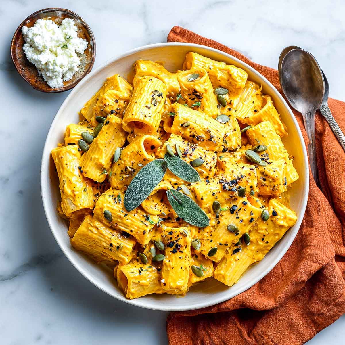 Pumpkin rigatoni with sage, cottage cheese, and black pepper in crockpot.
