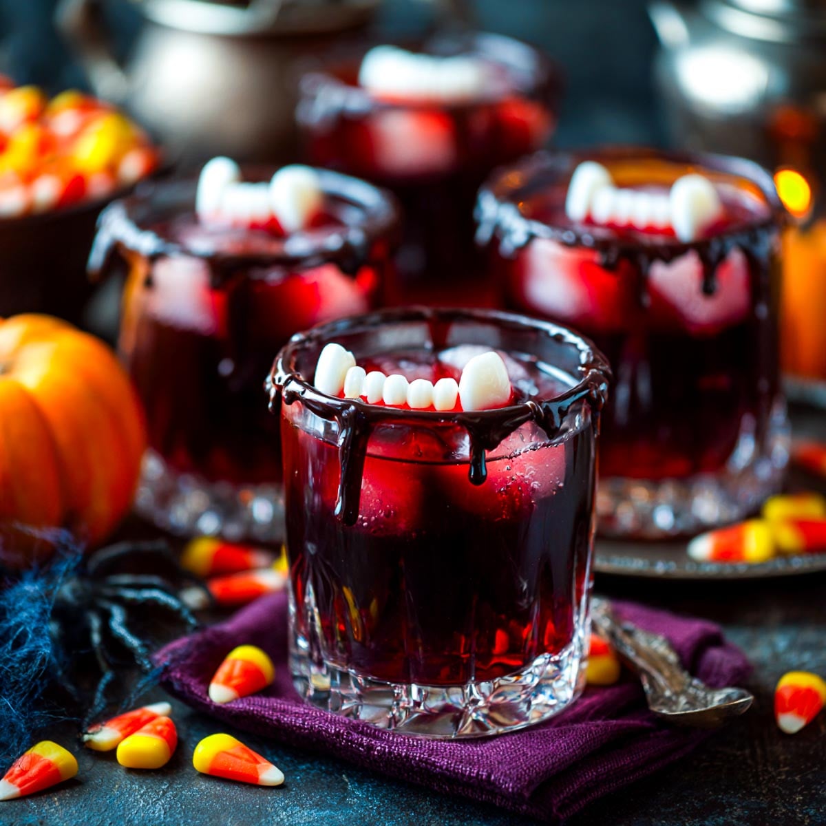 Red Halloween drink in glasses with floating vampire teeth fake fangs.