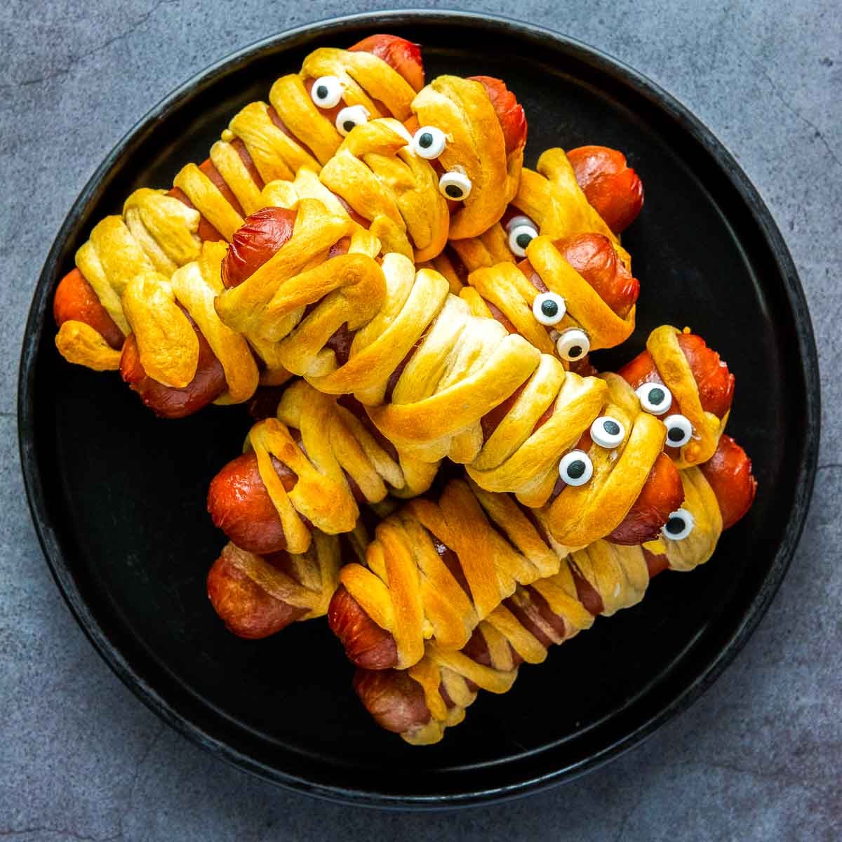 Hot dogs wrapped with crescent roll dough strips to resemble mummies