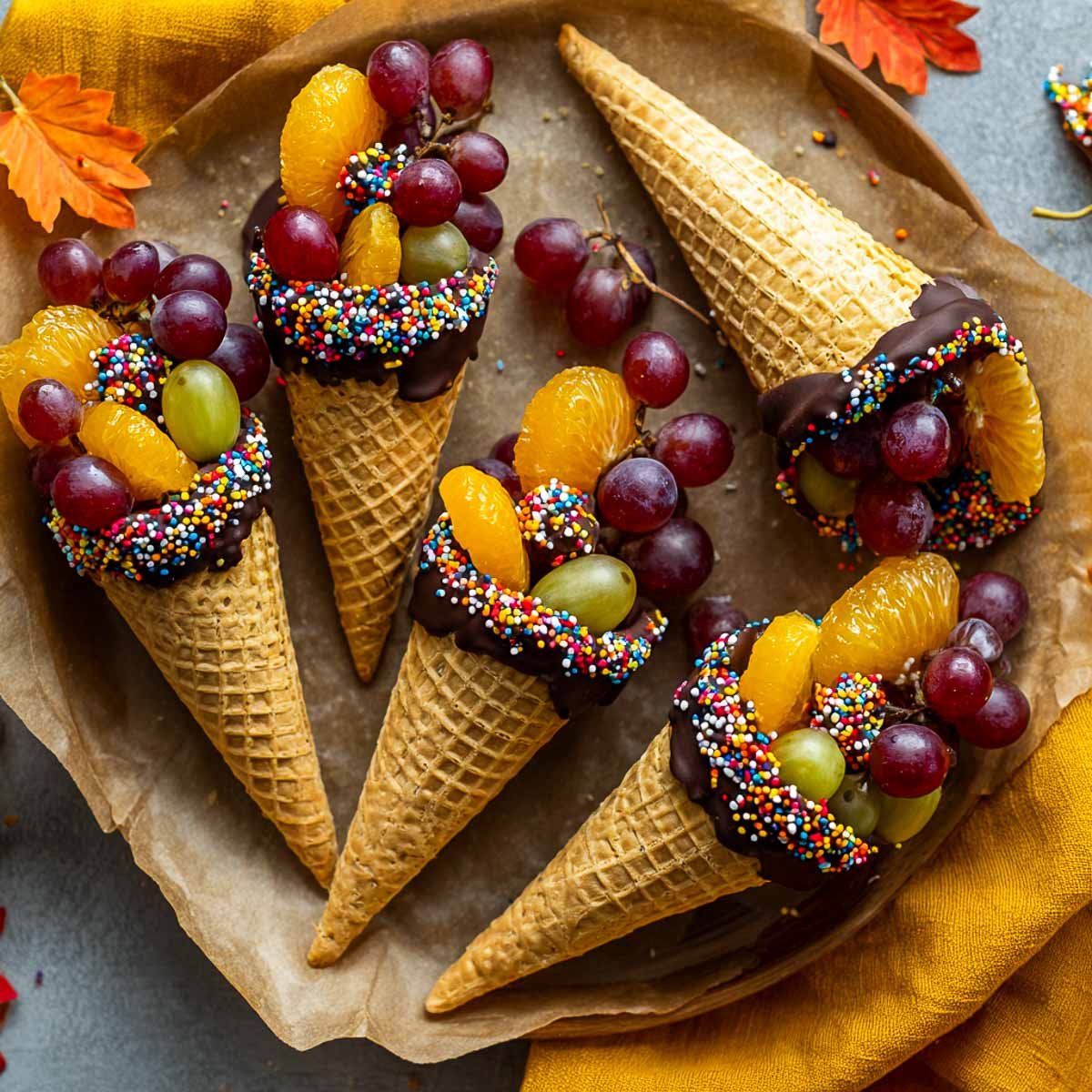 Gluten-free waffle cone cornucopias dipped in chocolate and sprinkles.