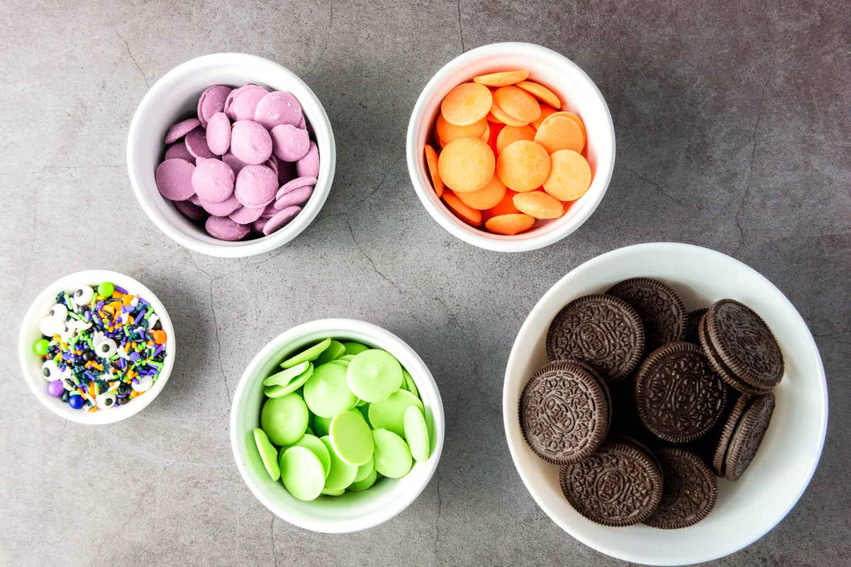 Bowls of Oreos, candy melts, sprinkles, and candy eyes for Halloween treats.