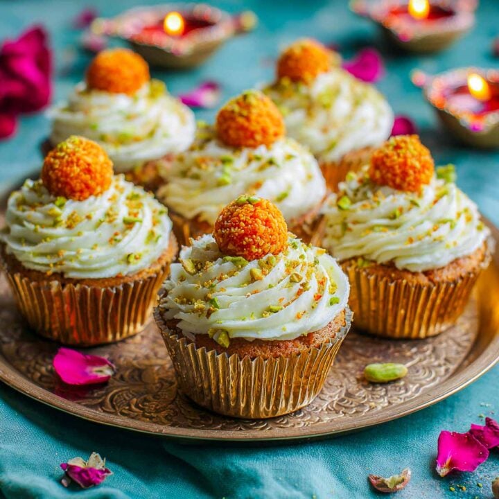 Cupcakes with buttercream frosting and a small motichoor ladoo topping.
