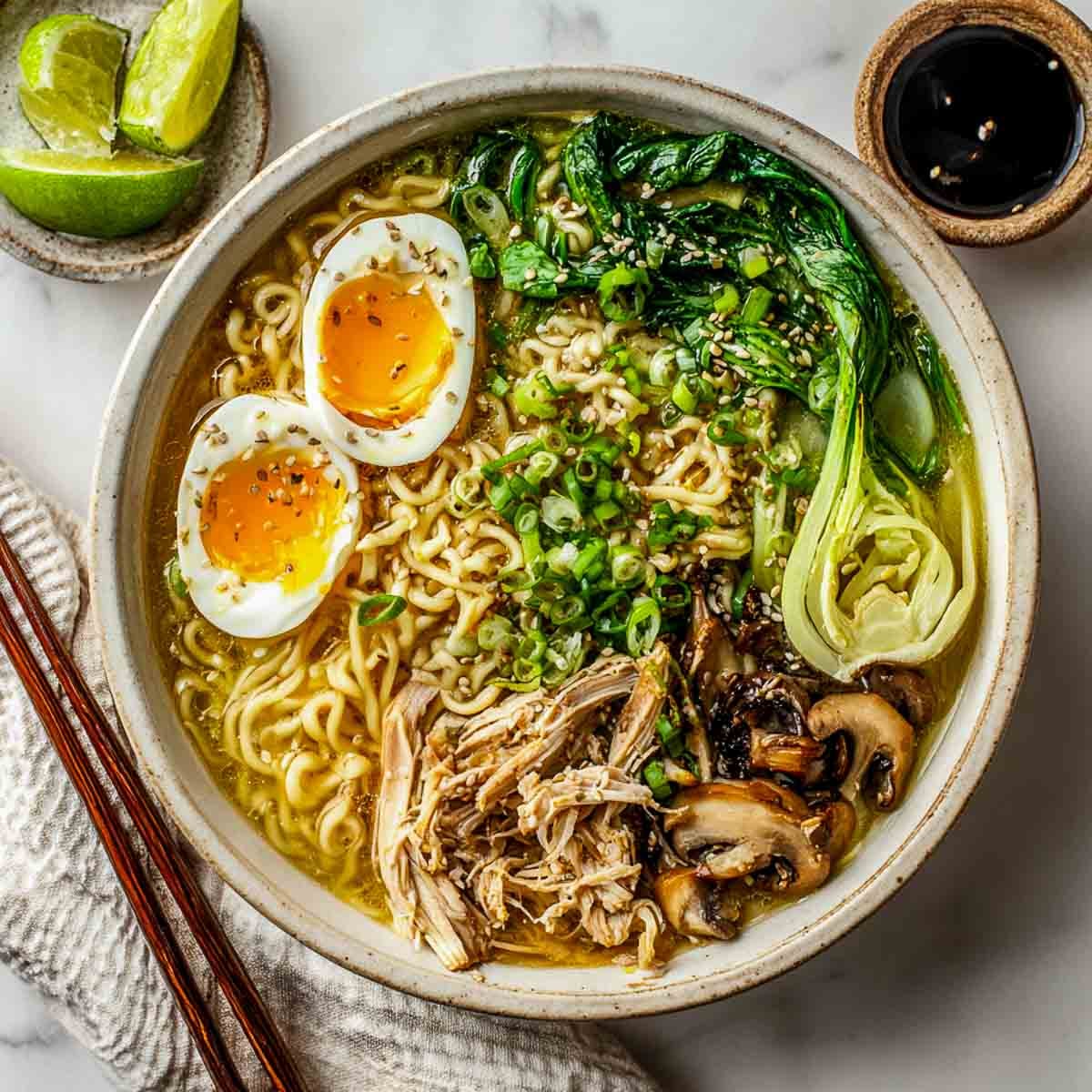 Leftover turkey ramen with noodles, bok choy, mushrooms, and soft-boiled eggs in a creamy golden broth.