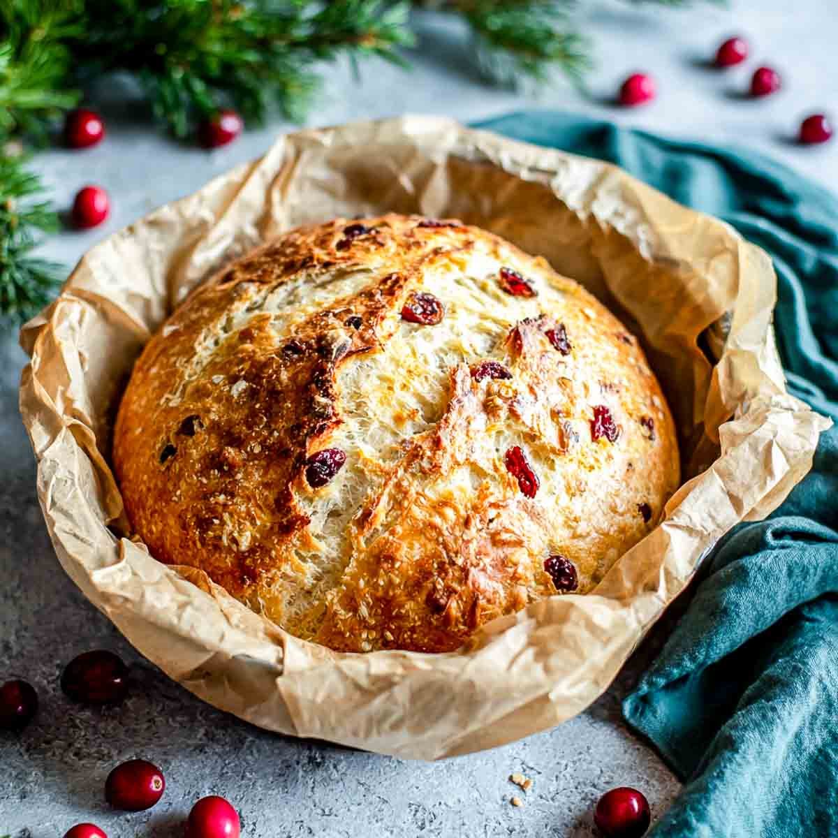 A loaf od cranberry walnut bread in a Dutch oven.