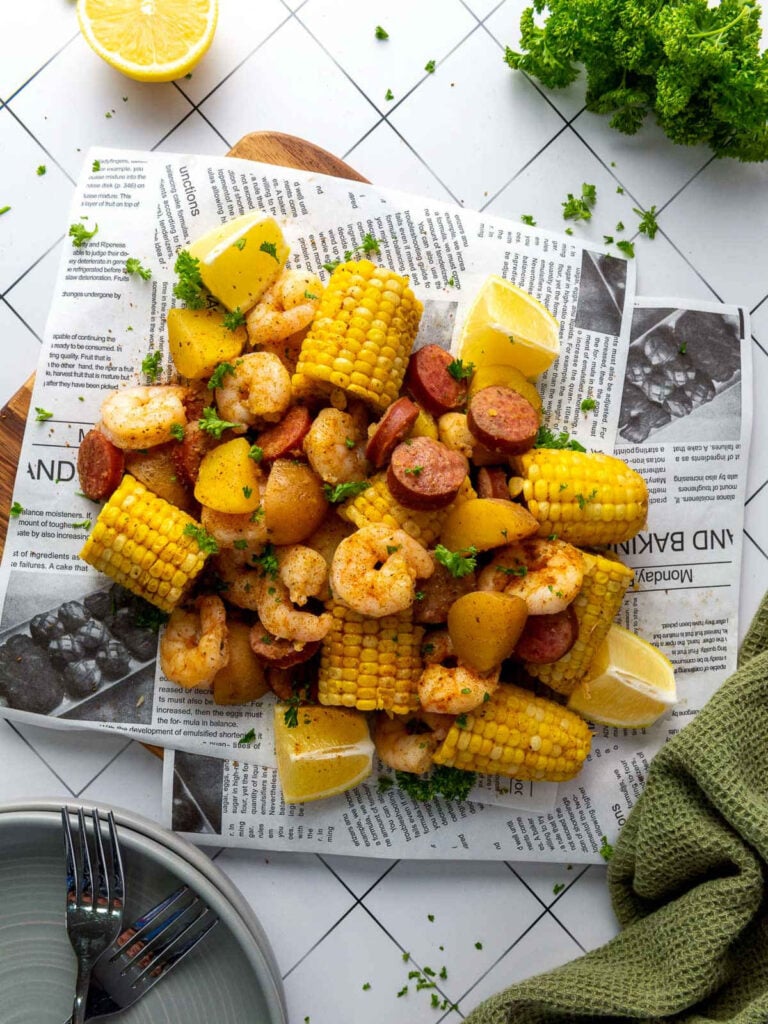 Instant Pot shrimp boil with corn, potatoes, sausage, and lemon.