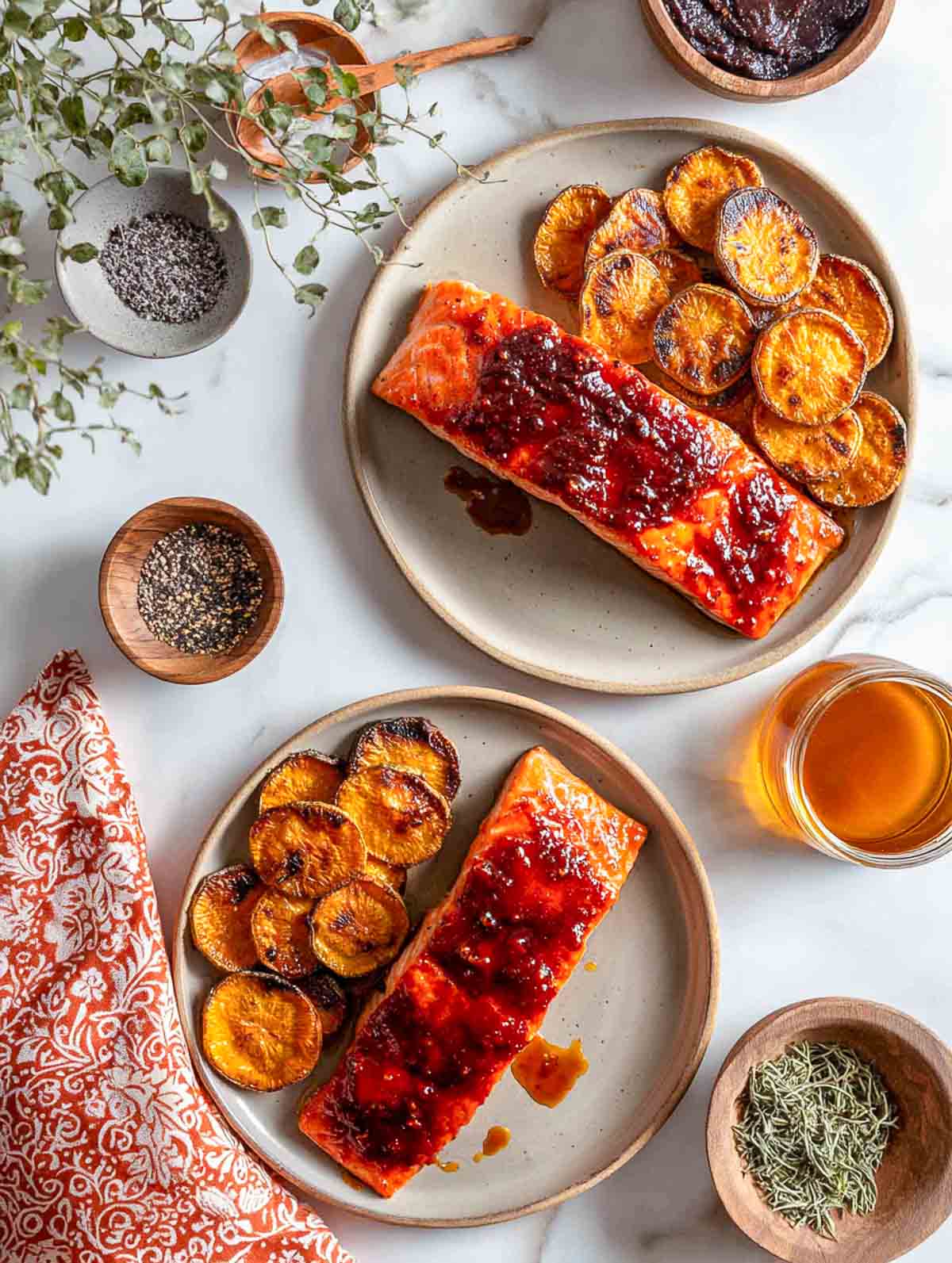 Harissa-honey glazed salmon fillets served with charred roasted sweet potato slices.