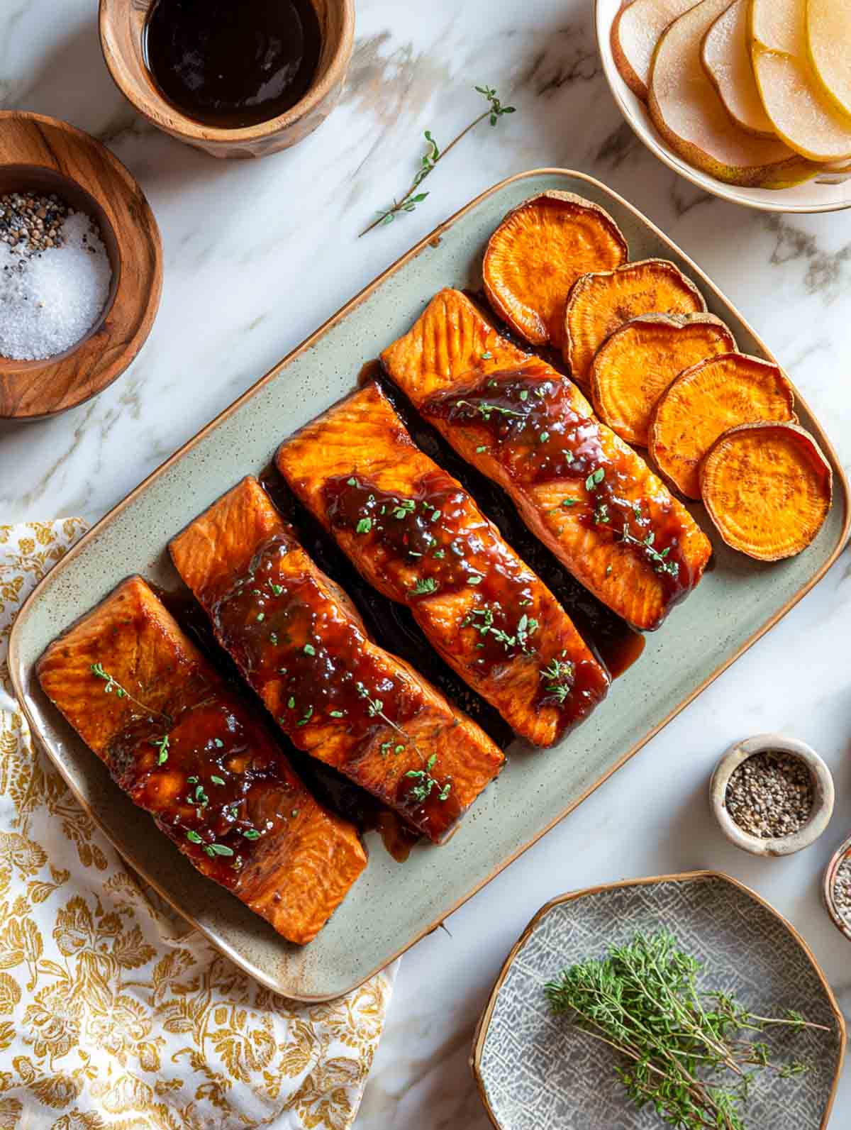 Pear-balsamic glazed salmon fillets with roasted sweet potato slices on platter.