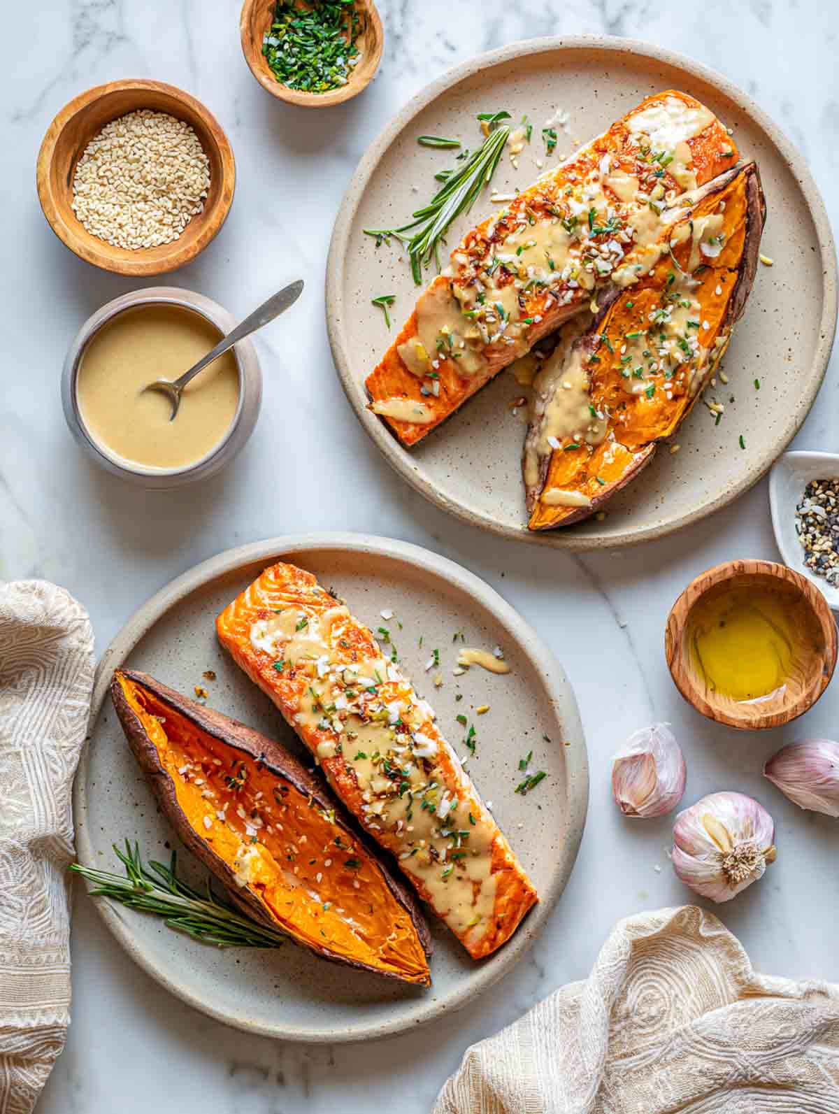 Tahini-garlic glazed salmon fillets served with roasted sweet potato halves.