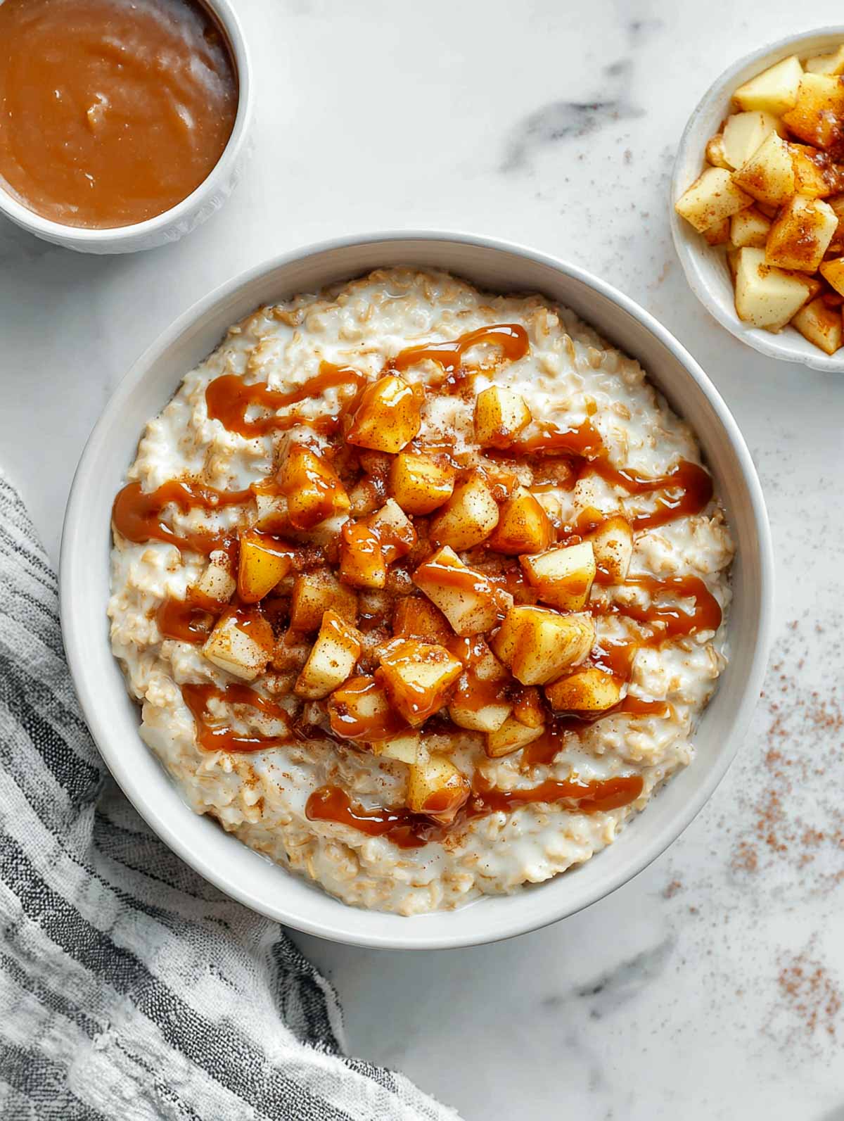 Apple pie microwave oatmeal with cinnamon apples and date caramel drizzle.