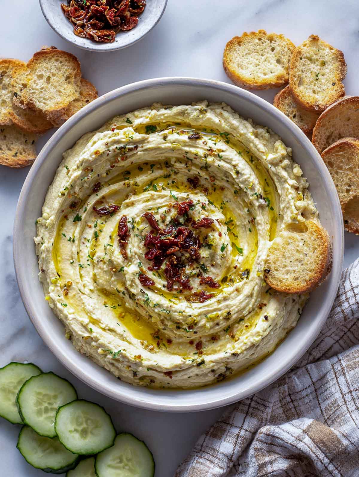 Butter bean dip with sun-dried tomatoes and toasted bread slices.