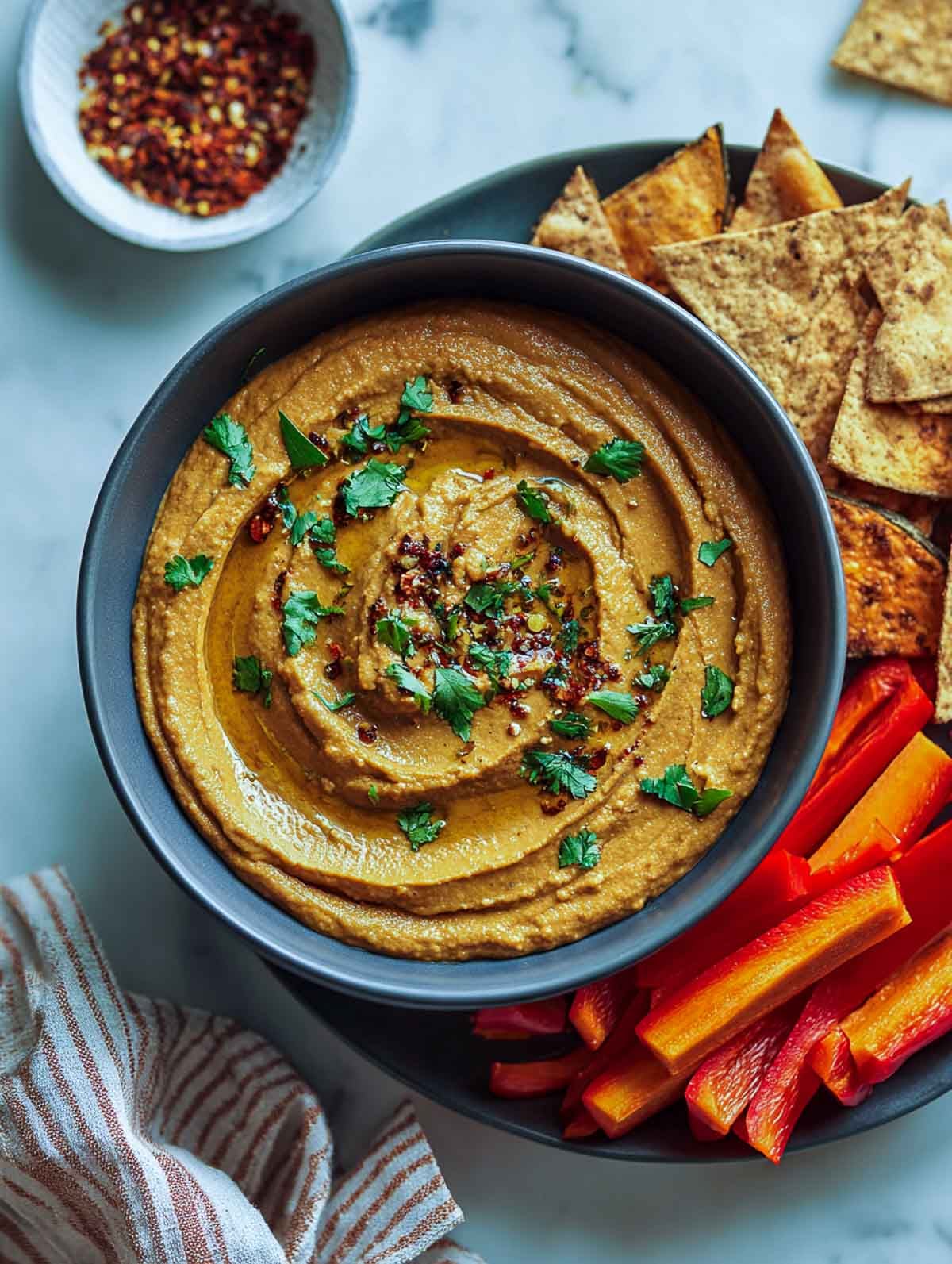 Smoky black bean chipotle dip served with tortilla chips and vegetables.