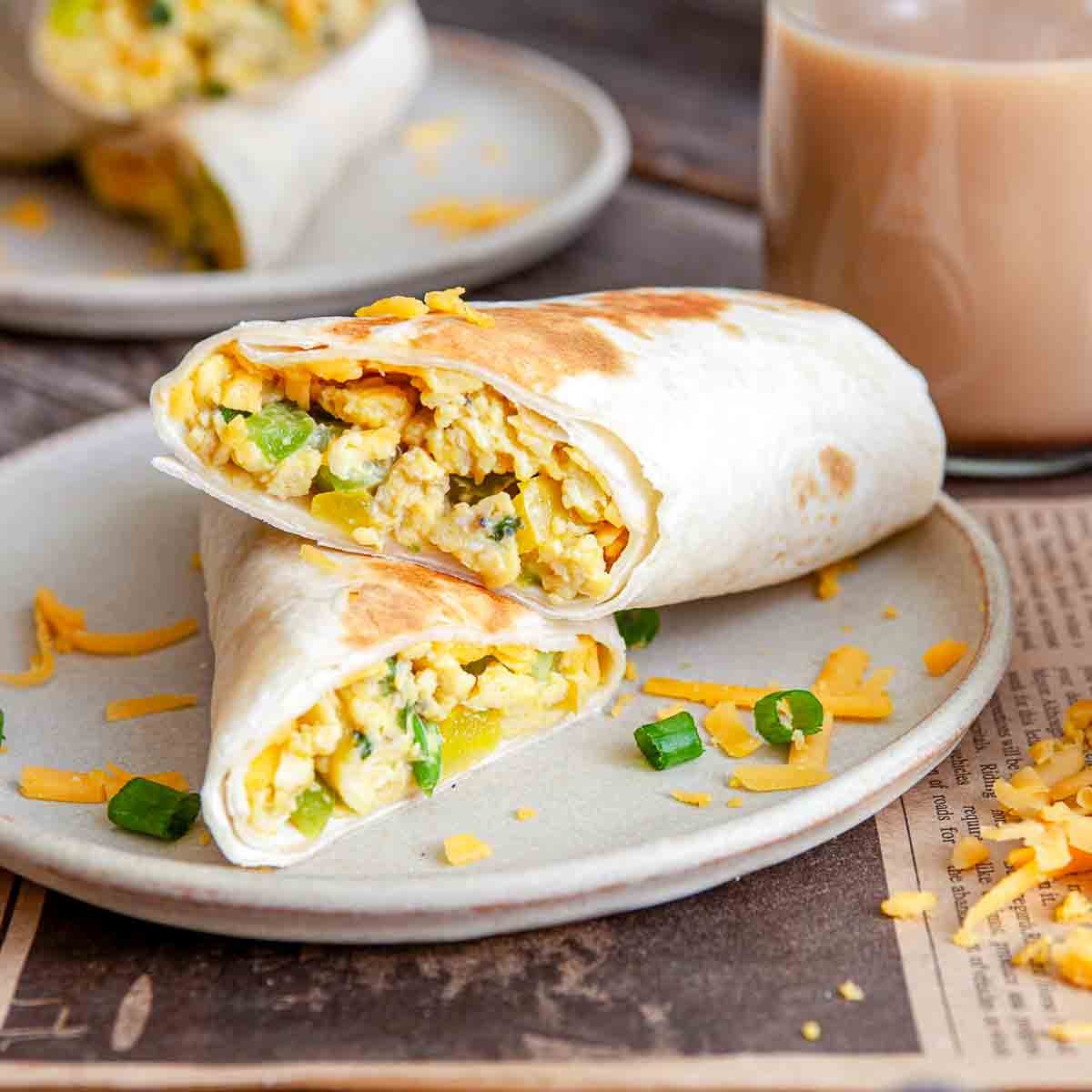 Breakfast burritos served with coffee and scrambled egg filling.