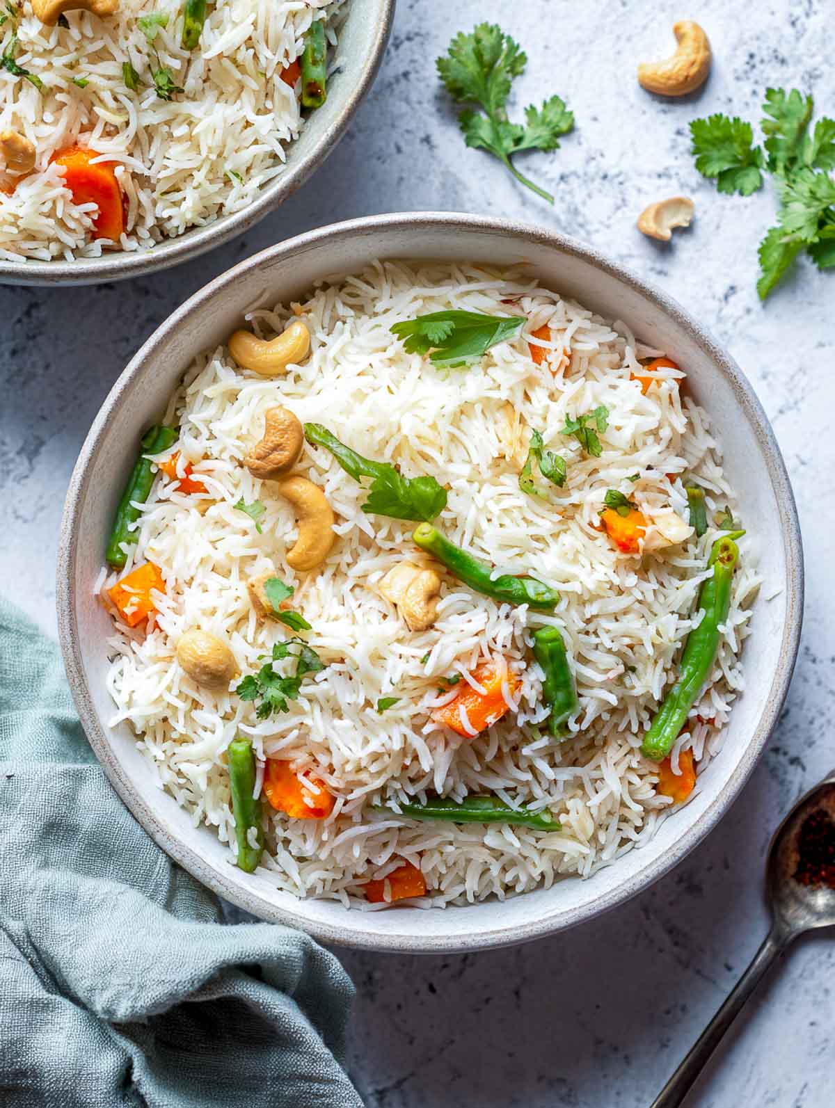 Coconut milk vegetable pulao with basmati rice, mixed vegetables, cashews, and whole spices.