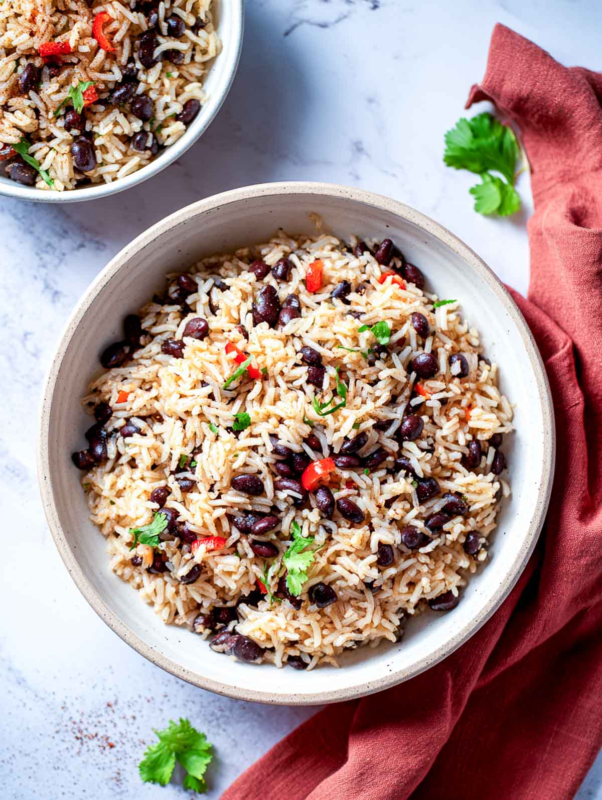 Mexican black bean rice cooker rice with cilantro and red pepper in a bowl.
