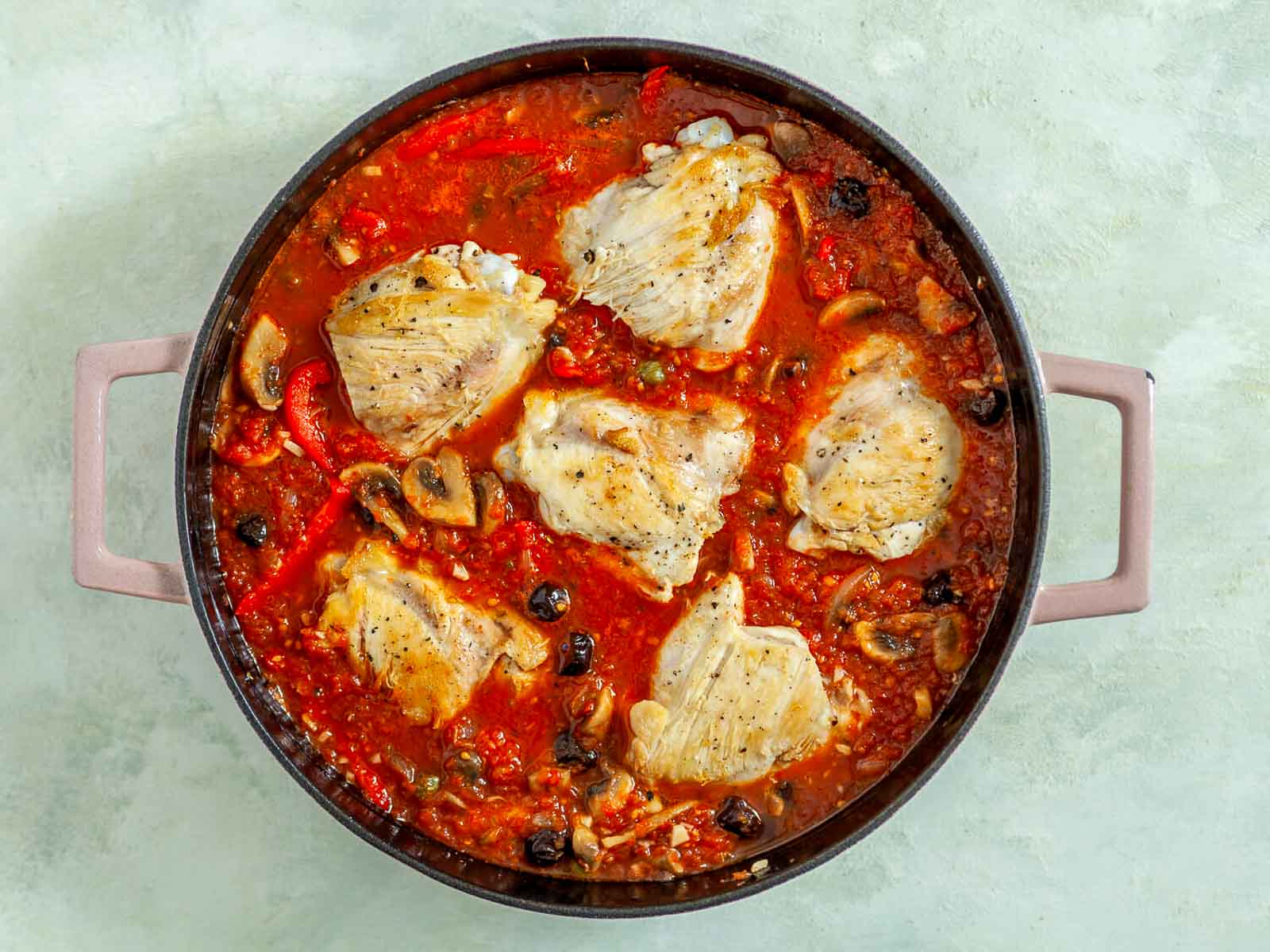 Chicken returned to the skillet and simmered in the sauce until tender and fully cooked.